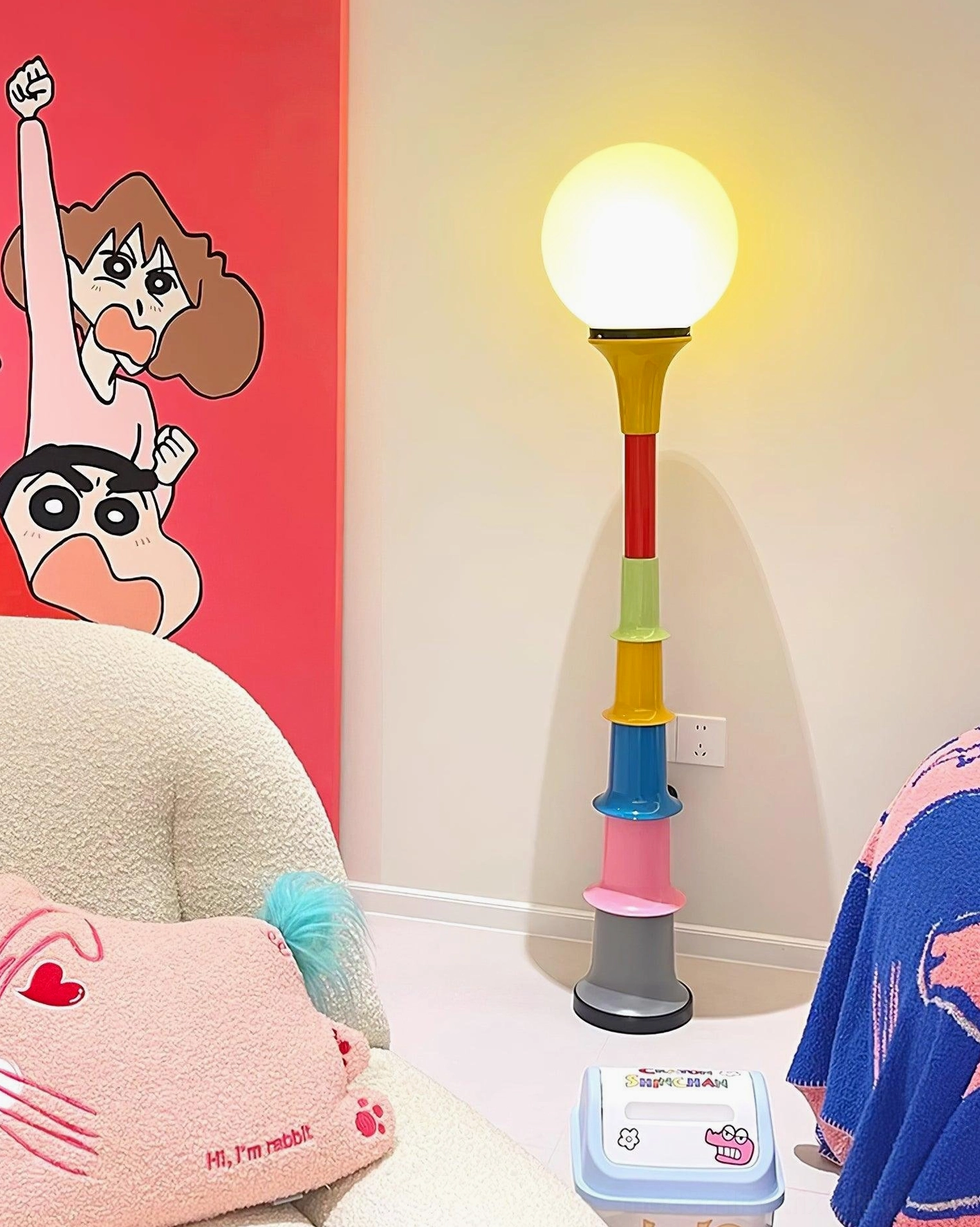 Colorful segmented globe floor lamp in playful cartoon-themed home corner creating cheerful lighting ambiance