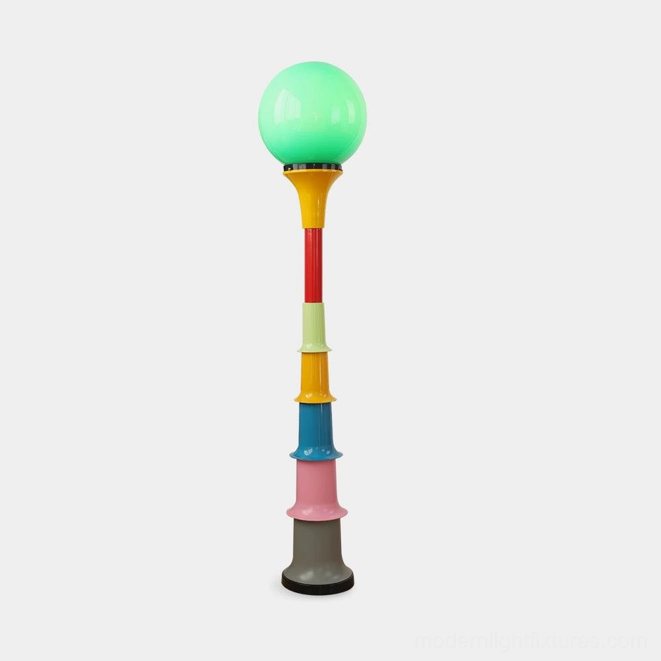 Colorful segmented floor lamp with globe shade - front view on white background showing stacked color-blocked design