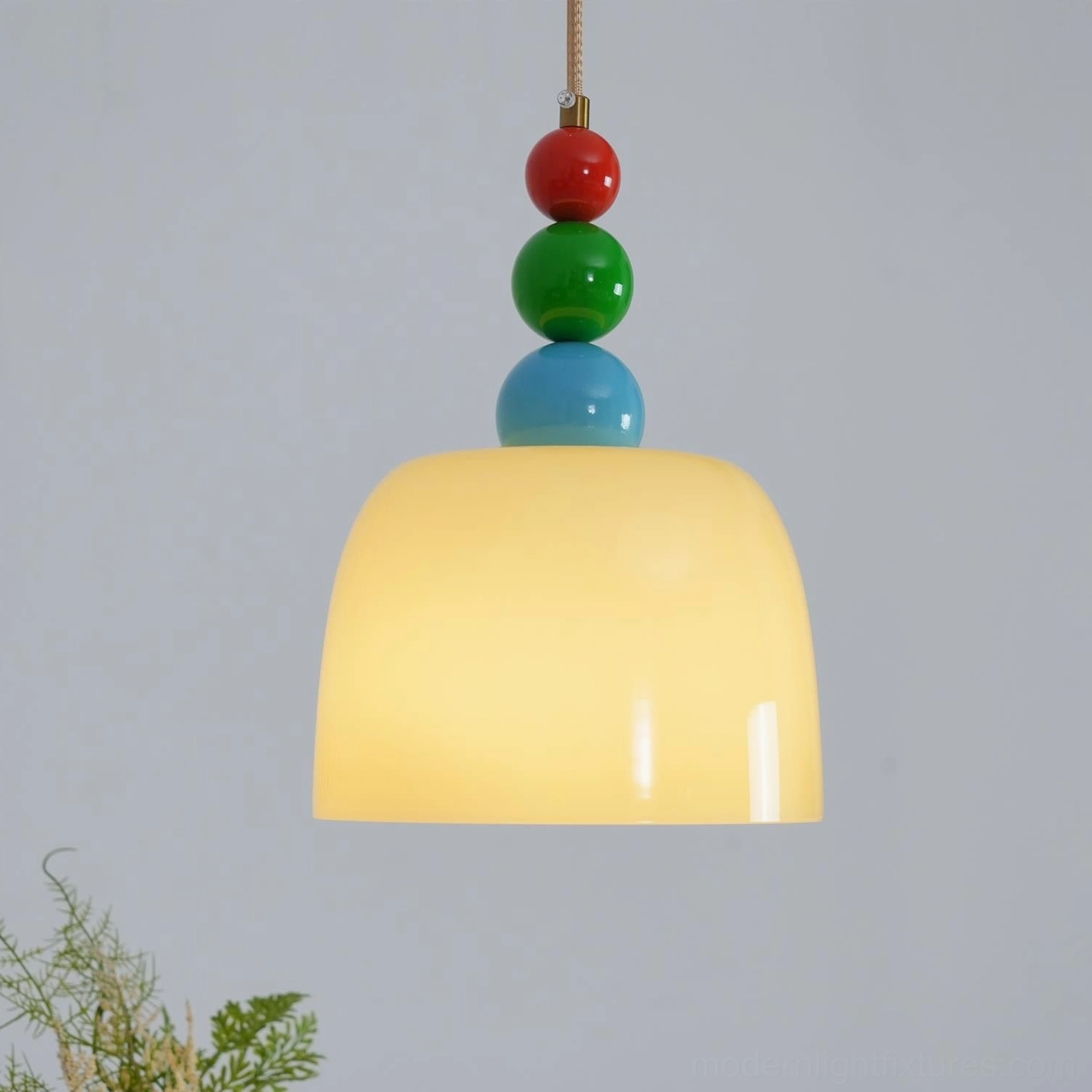 Playful stacked bead pendant light creating vibrant accent in neutral interior space