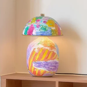 Artistic table lamp with warm LED glow on wooden side table in home interior setting