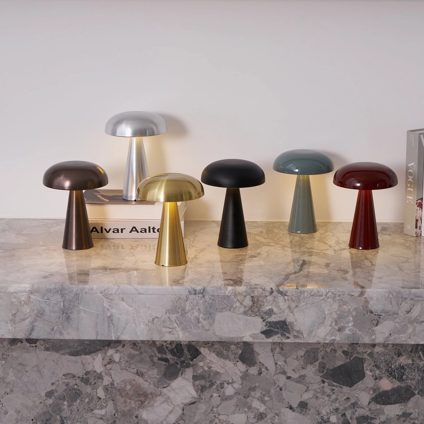 Complete Como table lamp collection five color variants arranged overhead on marble countertop minimalist display