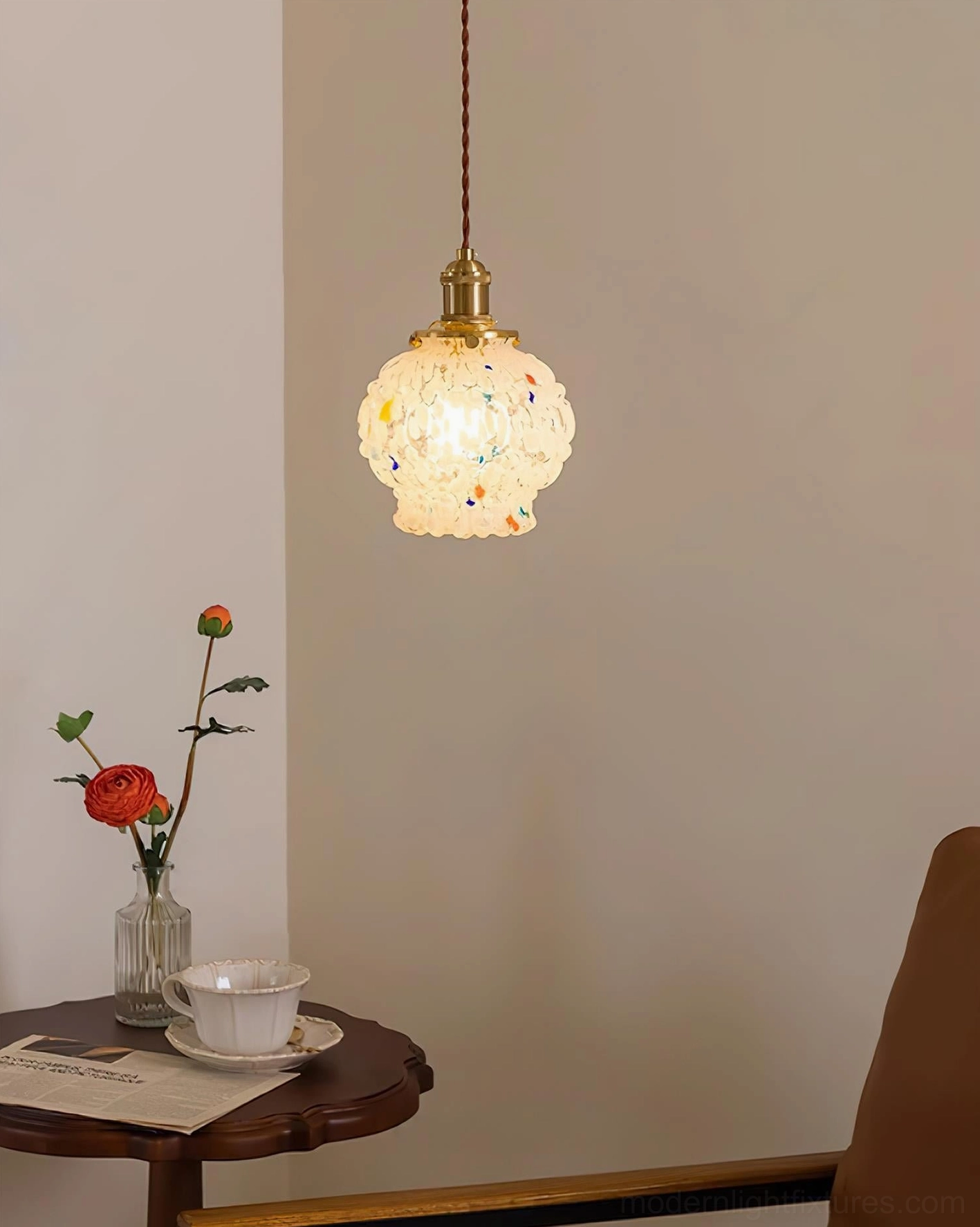 Mini hand-blown glass pendant light with warm ambient lighting, compact modern fixture in home lounge area