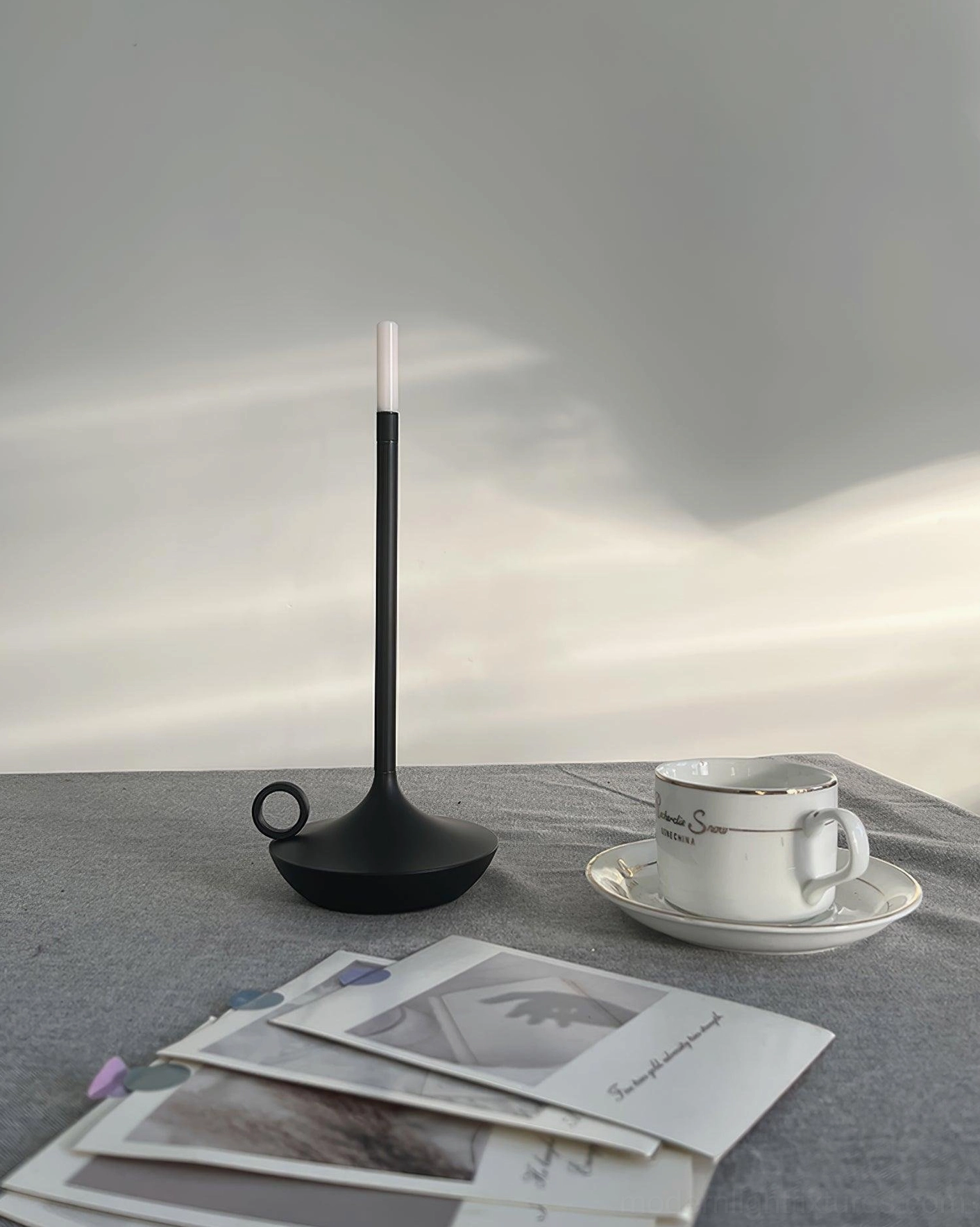 Compact modern LED table lamp with integrated design on decorative surface styled with accessories