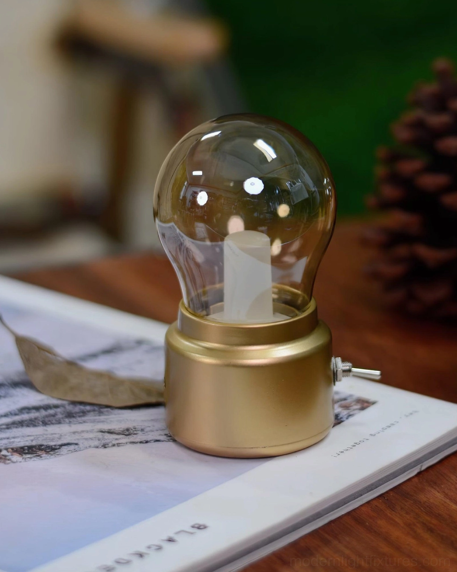 Compact miniature table lamp palm-sized proportions aesthetic impact design