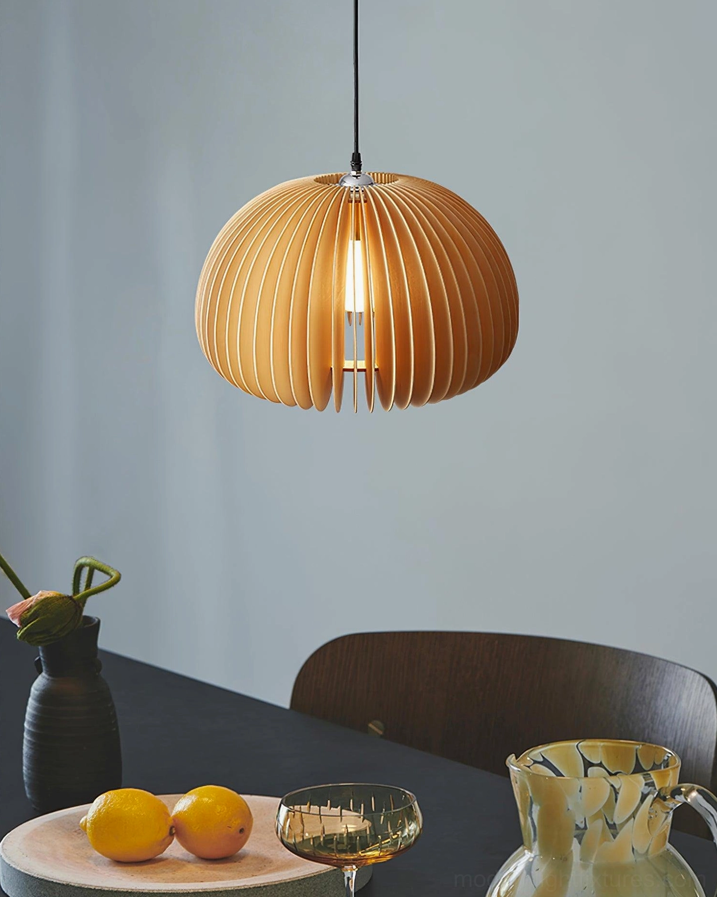 Medium wood pumpkin pendant light over modern dining table with minimalist style aesthetic