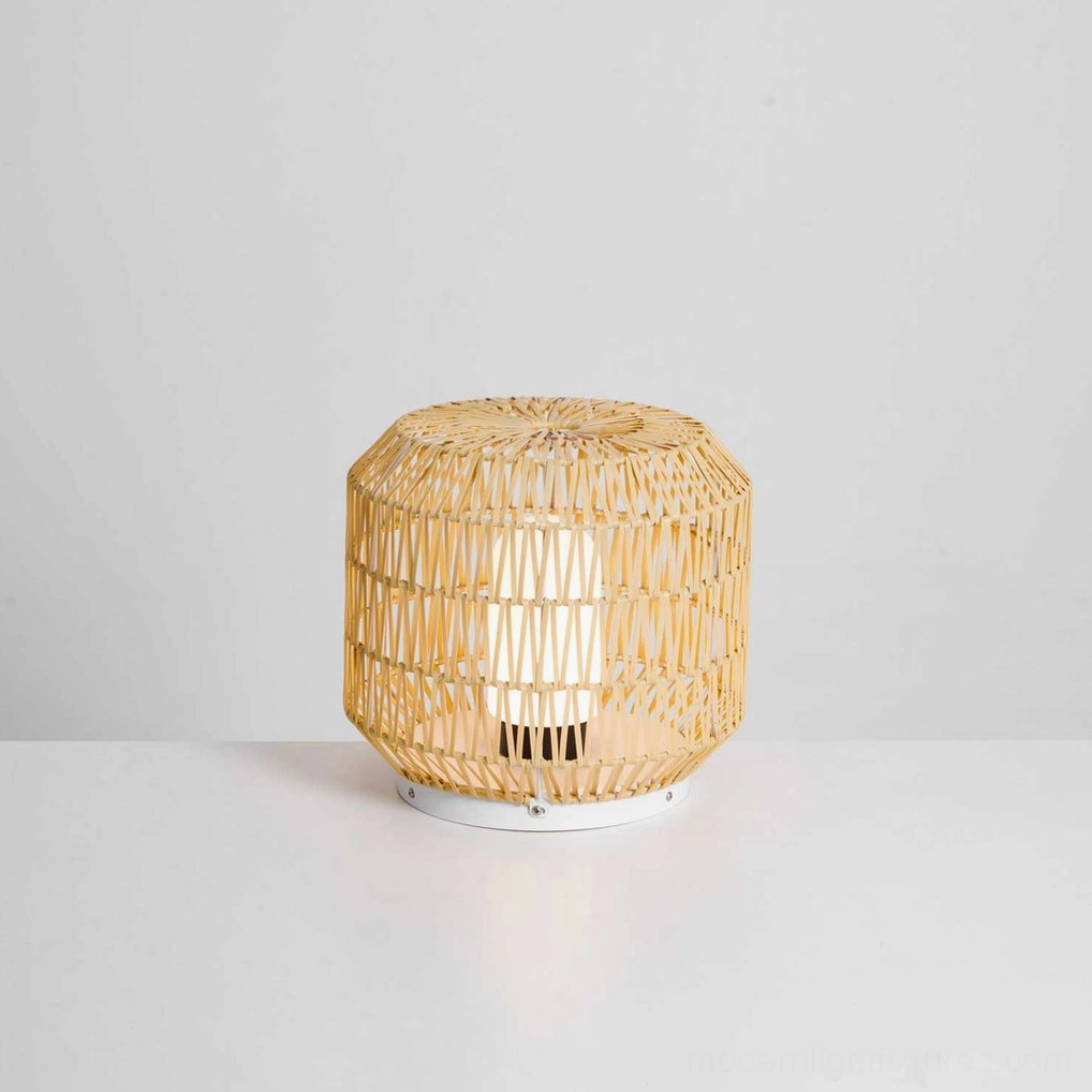 Compact short round rattan table lamp on white surface, minimalist boho studio product display