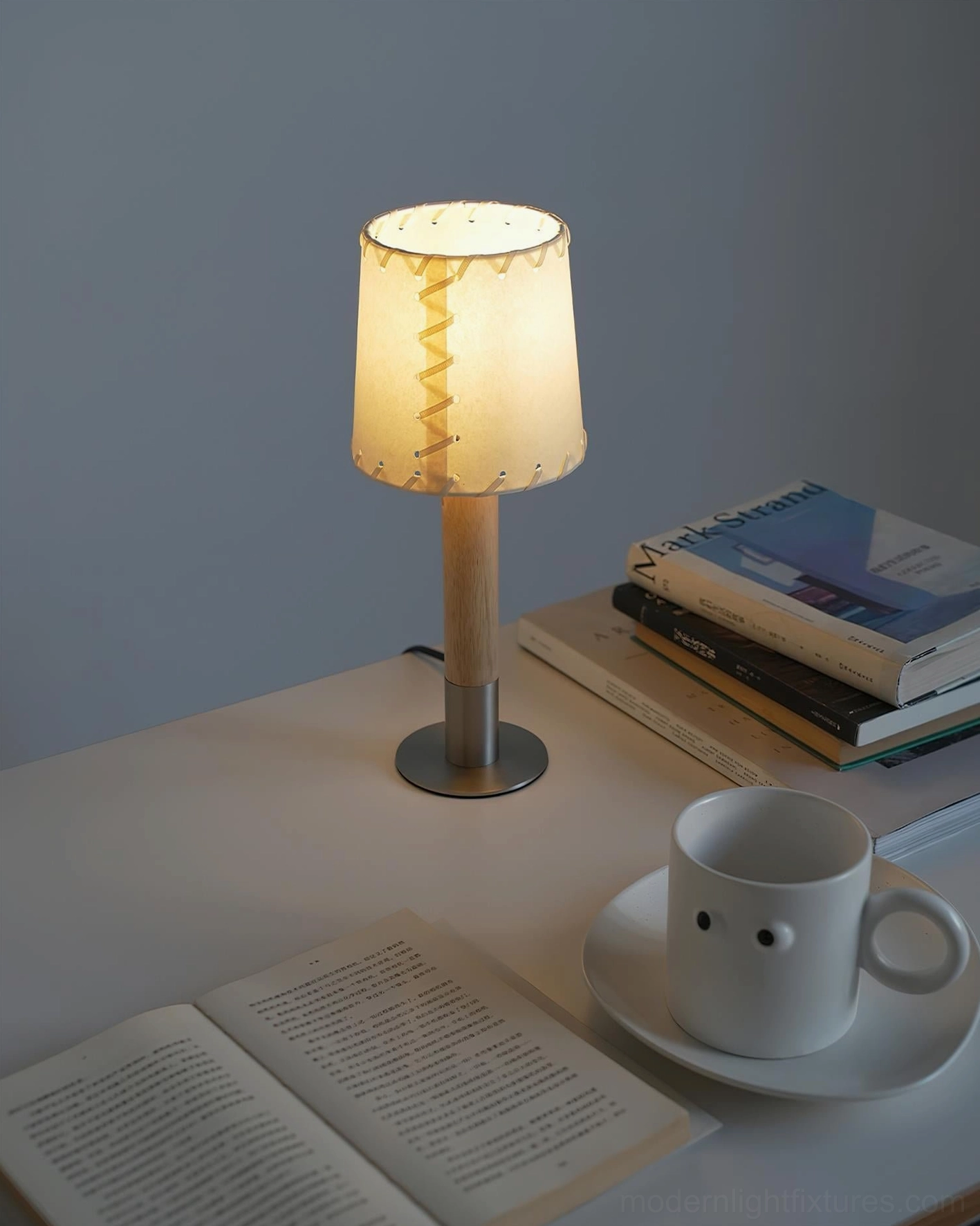 Compact table lamp on home office desk with books and warm lighting - modern workspace accent