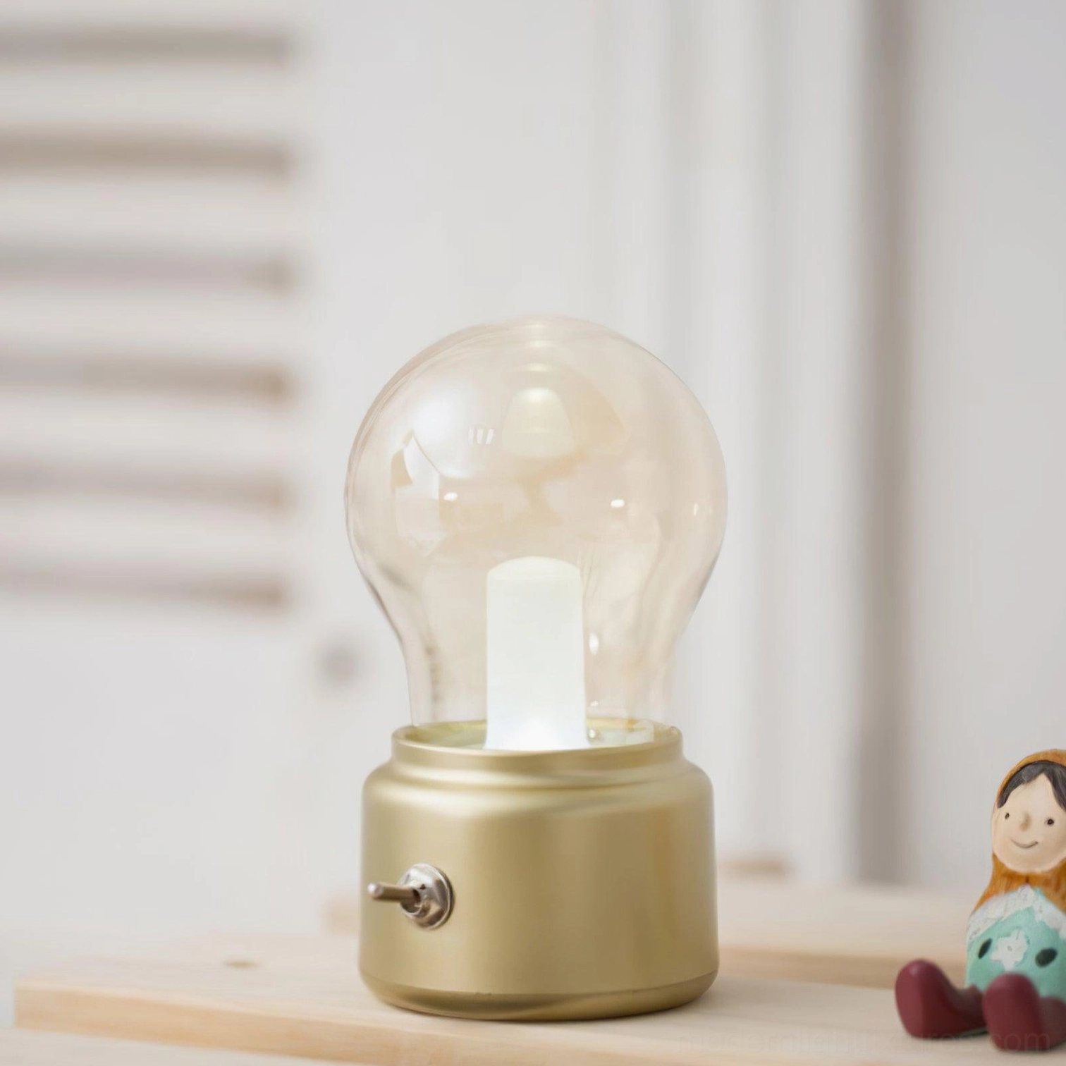 Modern compact table lamp with metal base and glass bulb shade for small spaces