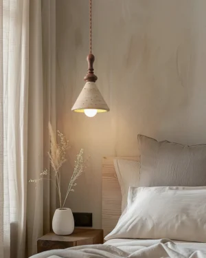 Conical travertine pendant lamp in bedroom setting, warm wabi-sabi rustic minimalist style with natural stone