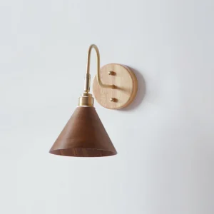Conira Japandi wall lamp showing brass hardware and wood shade detail - flat lay side angle