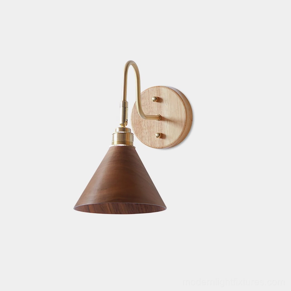 Conira minimalist wall sconce with conical walnut shade and brass curved arm - front view studio photography