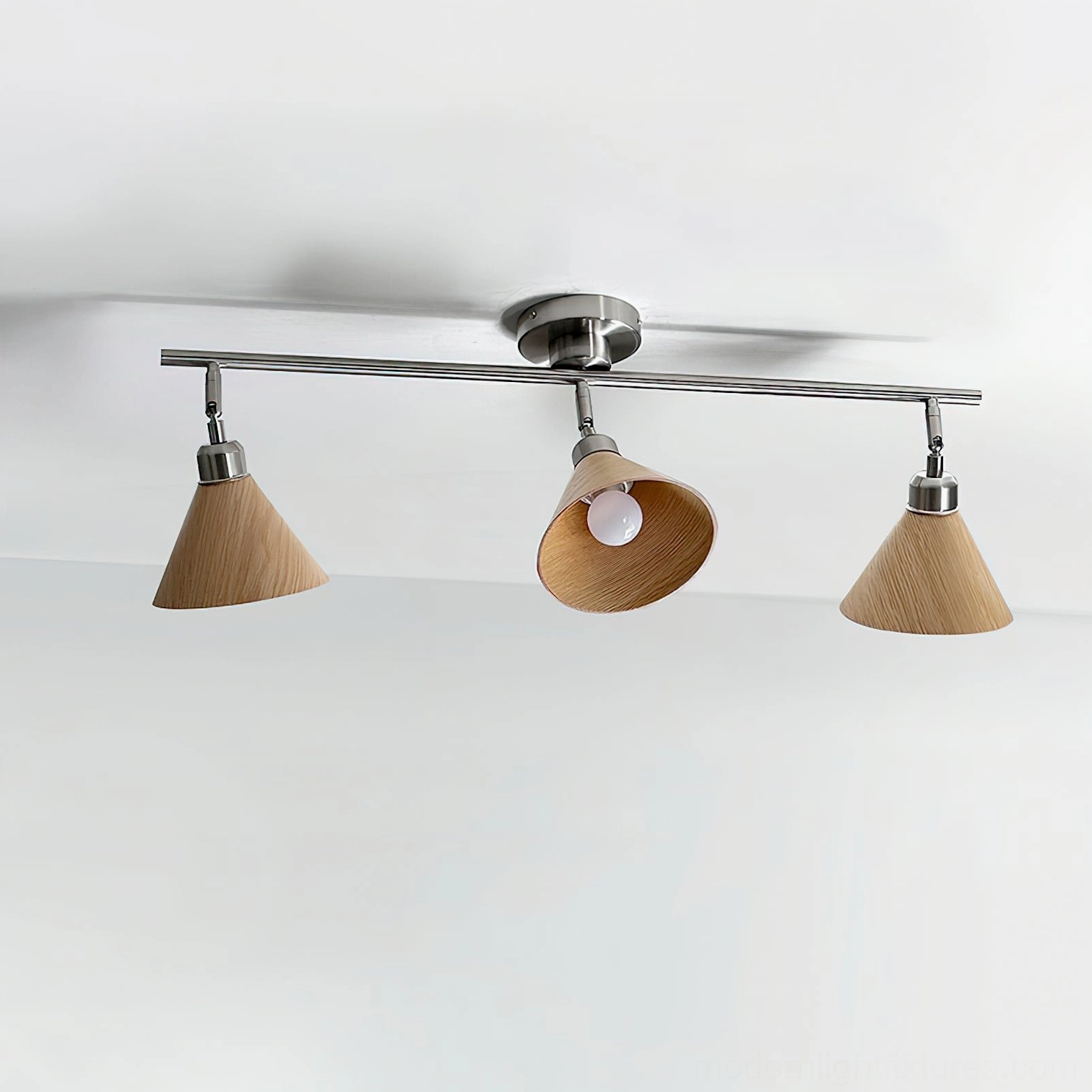 Conistra 3-head track ceiling spotlight showing natural light wood grain lamp shades with visible bulb and brushed nickel frame