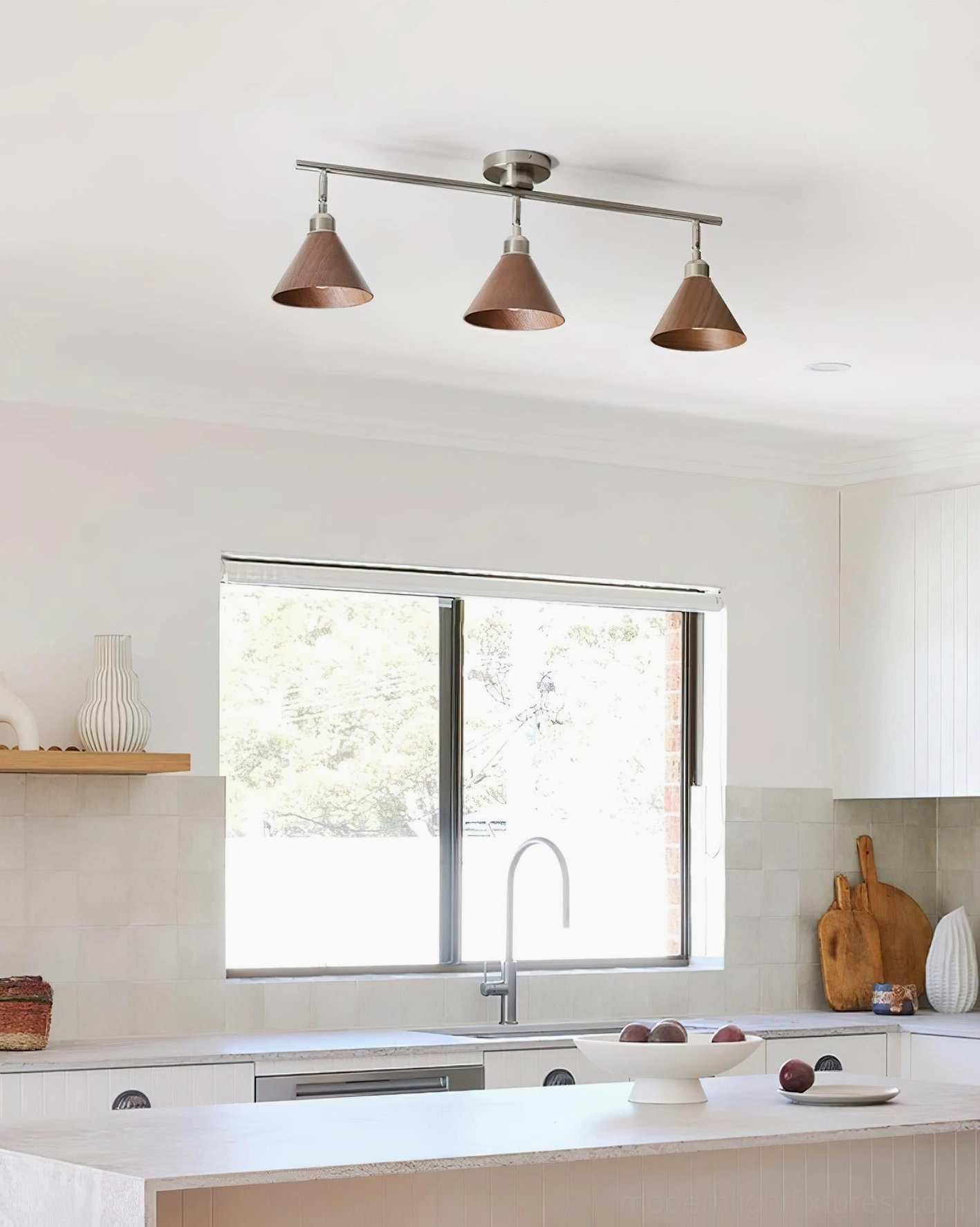 Conistra 3-light track ceiling lamp mounted in modern kitchen with island counter and clean minimalist style