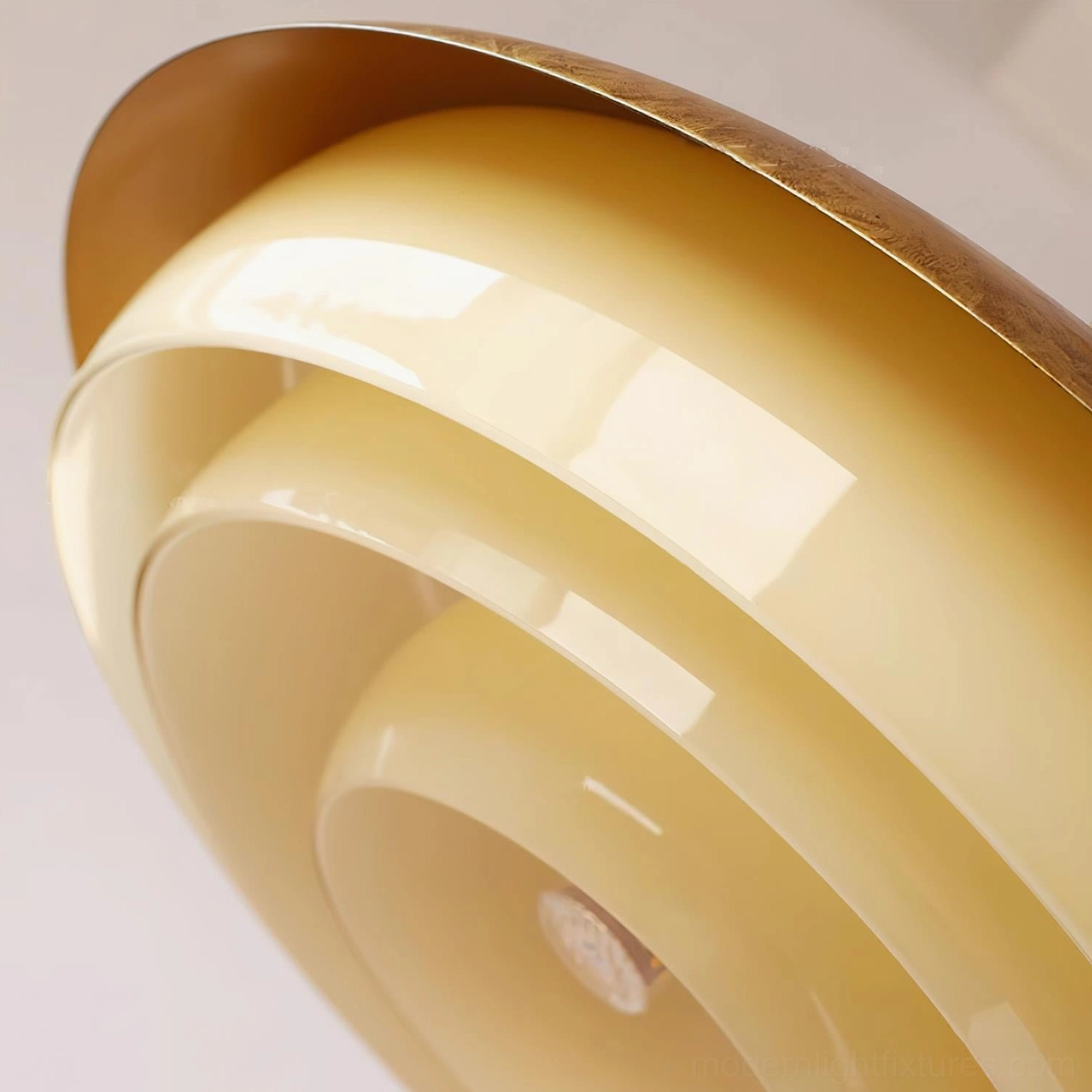 Contemporary aged brass pendant lamp with cream glass, styled with accessories and décor elements