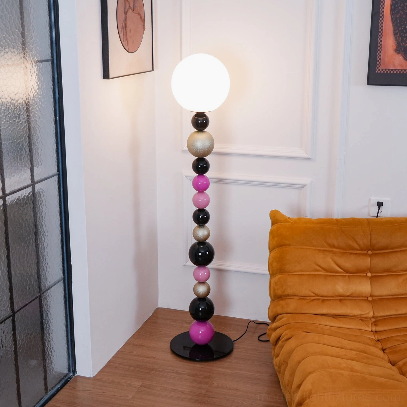 Colorful spherical bead floor lamp in minimalist living room with orange sofa and wall panels, modern interior