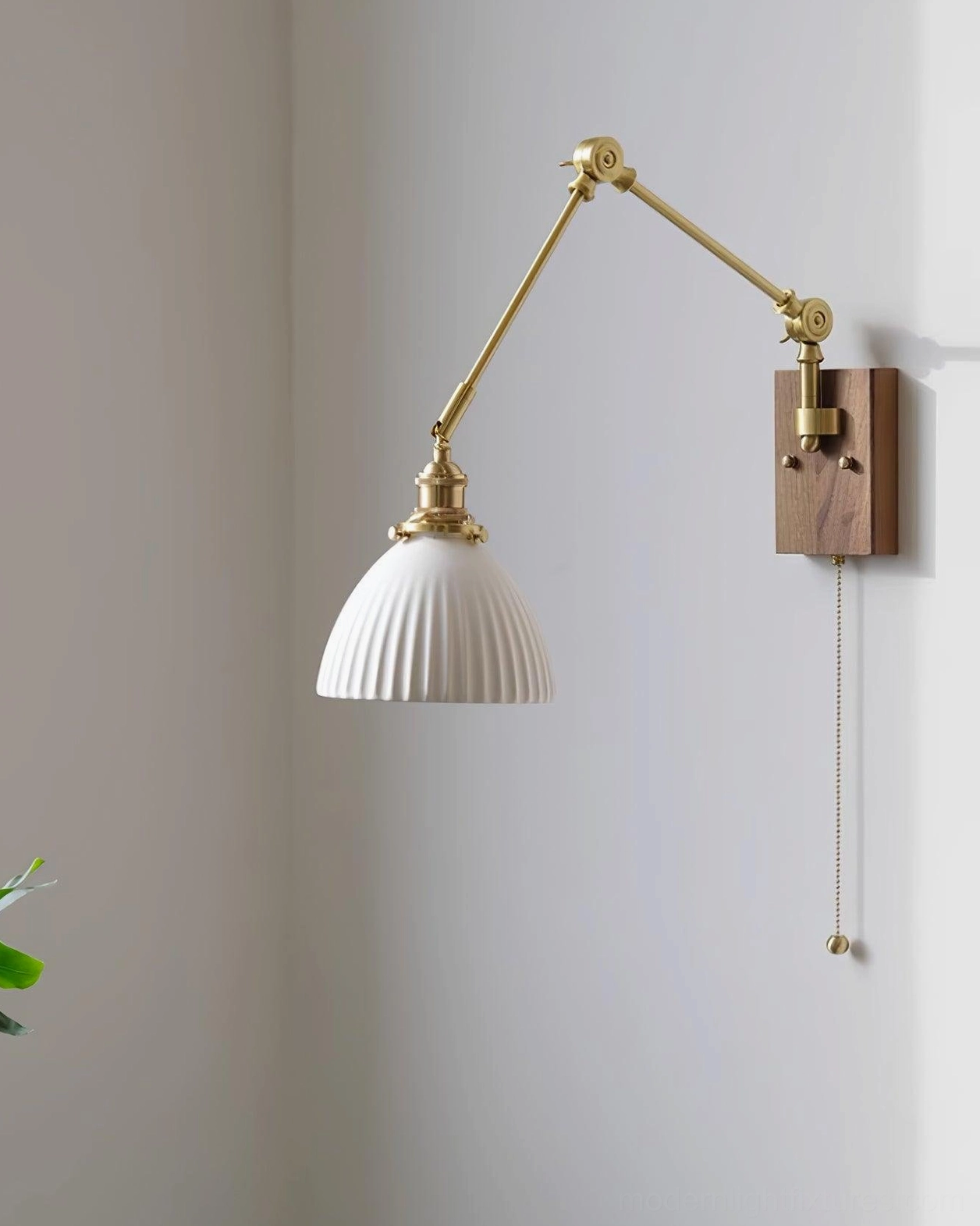 Contemporary swing arm wall sconce with brass finish and white ceramic dome shade