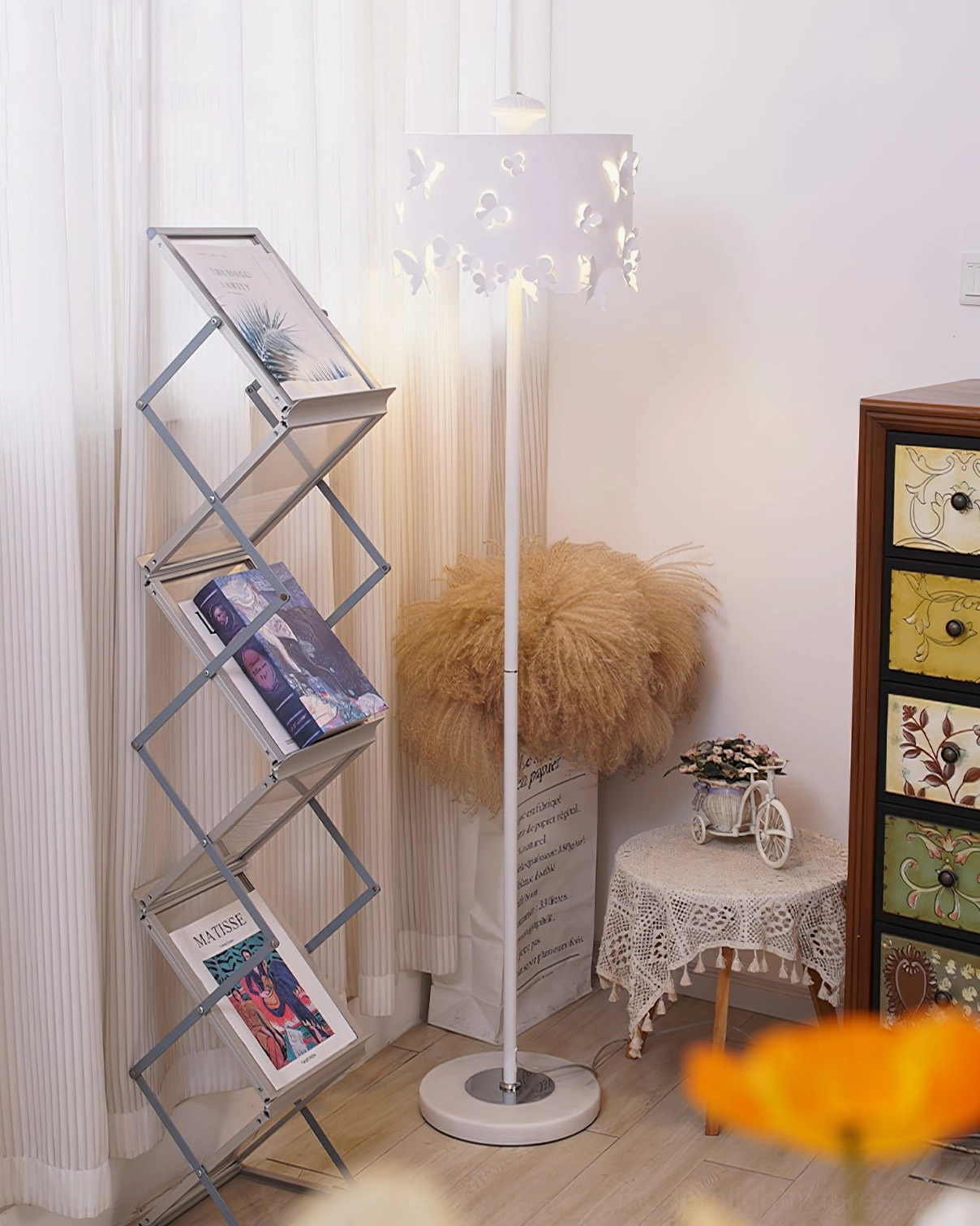 Butterfly floor lamp in vintage living room nook beside magazine rack, soft ambient lighting with decorative furniture