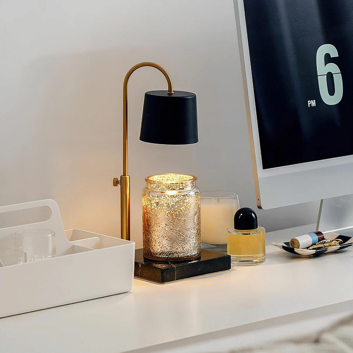Black fabric shade candle warmer lamp with brass gold frame on dark square base side desk perspective