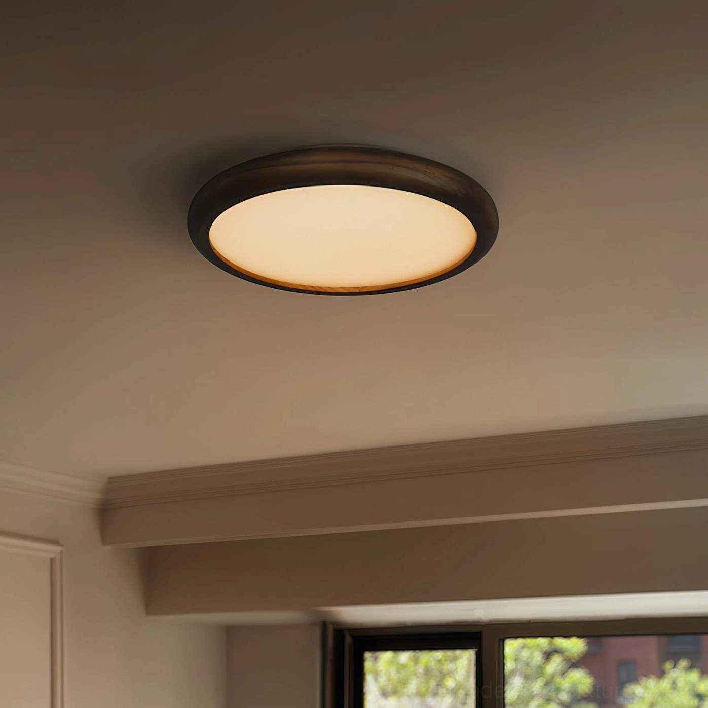 Contemporary flush mount ceiling fixture in dining room interior, upward view showing illuminated warm white light