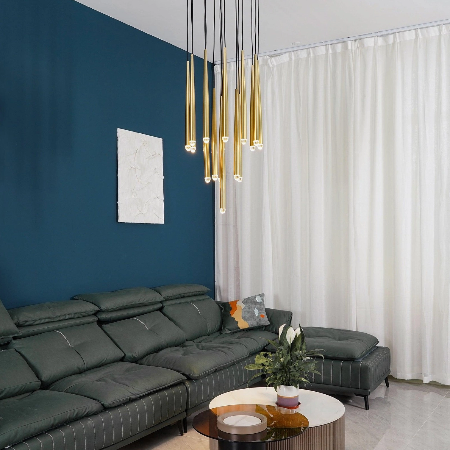 Linear suspended tapered rod chandelier in sophisticated lounge with leather sofa