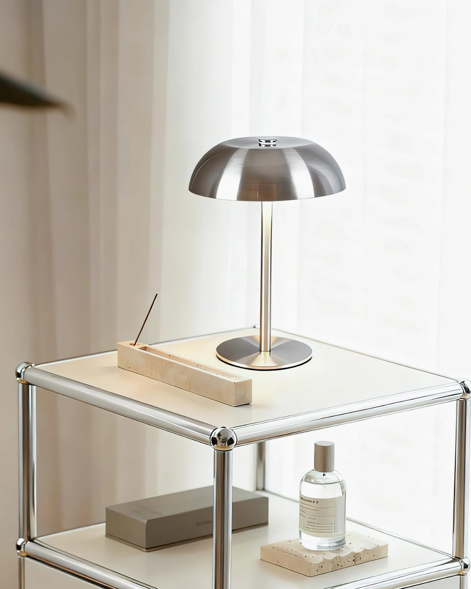 Contemporary metal table lamp in minimalist home office space with desk accessories and storage