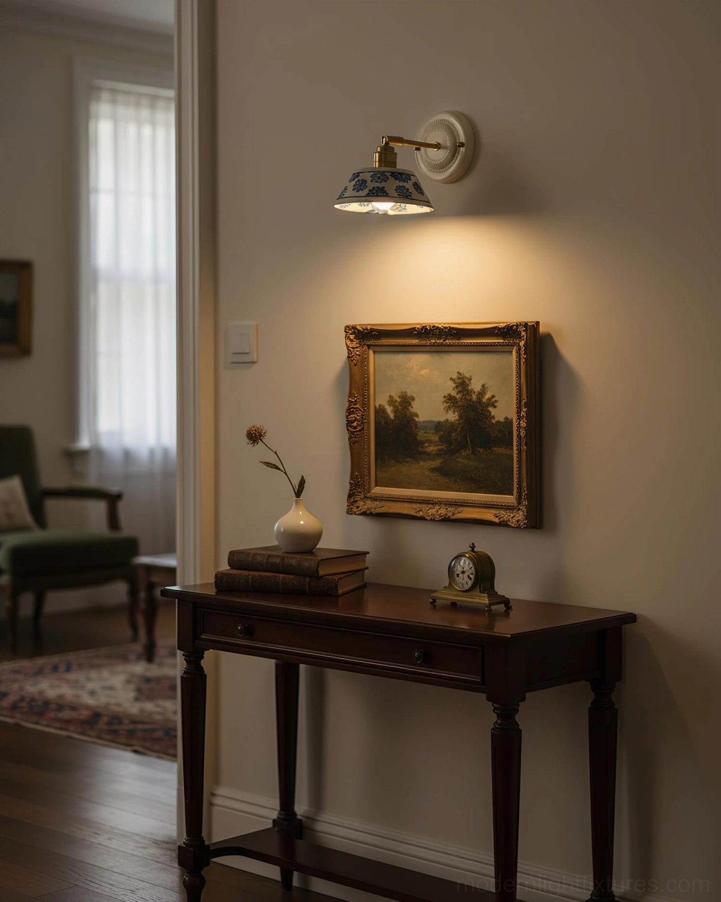 Hand-glazed indigo sconce in home entryway above wooden console table with framed art
