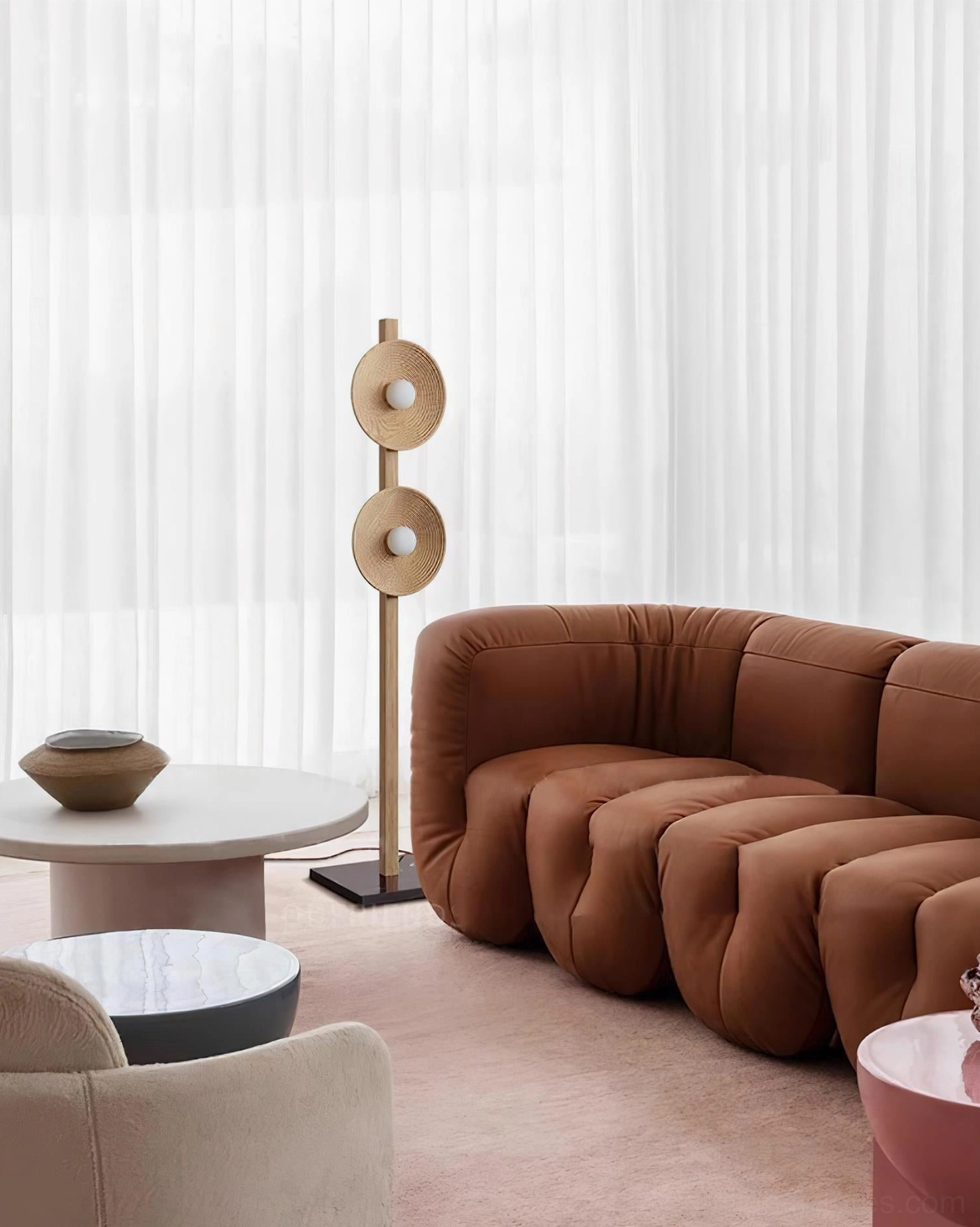 Twin disc floor lamp styled in contemporary living room beside sofa and window with minimalist decor