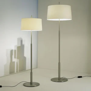 Pair of matching chrome floor lamps with off-white fabric shades in minimalist corner interior