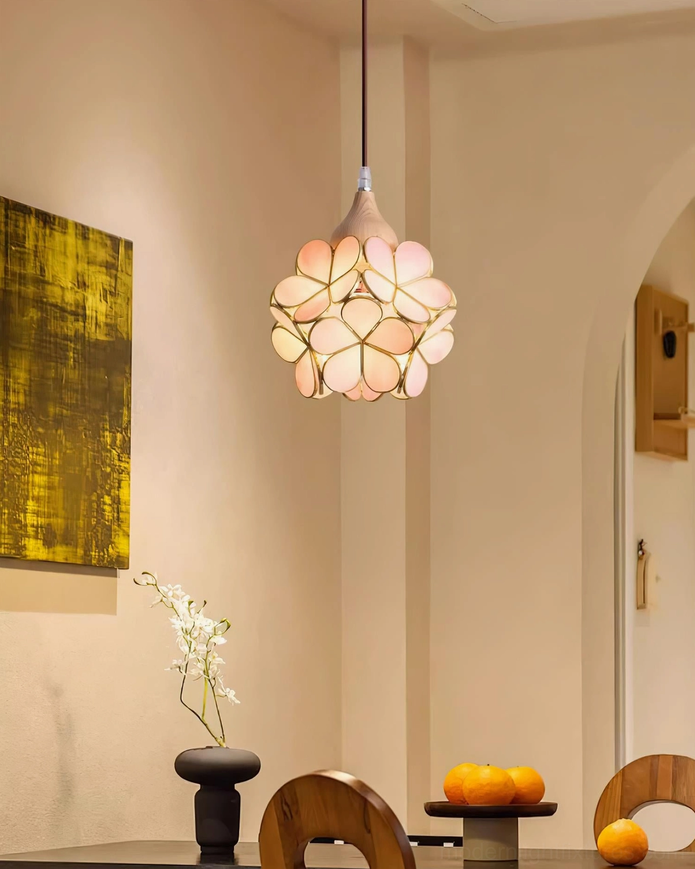 Contemporary flower pendant light with pink glass petals and natural wood frame, hanging in minimalist interior space