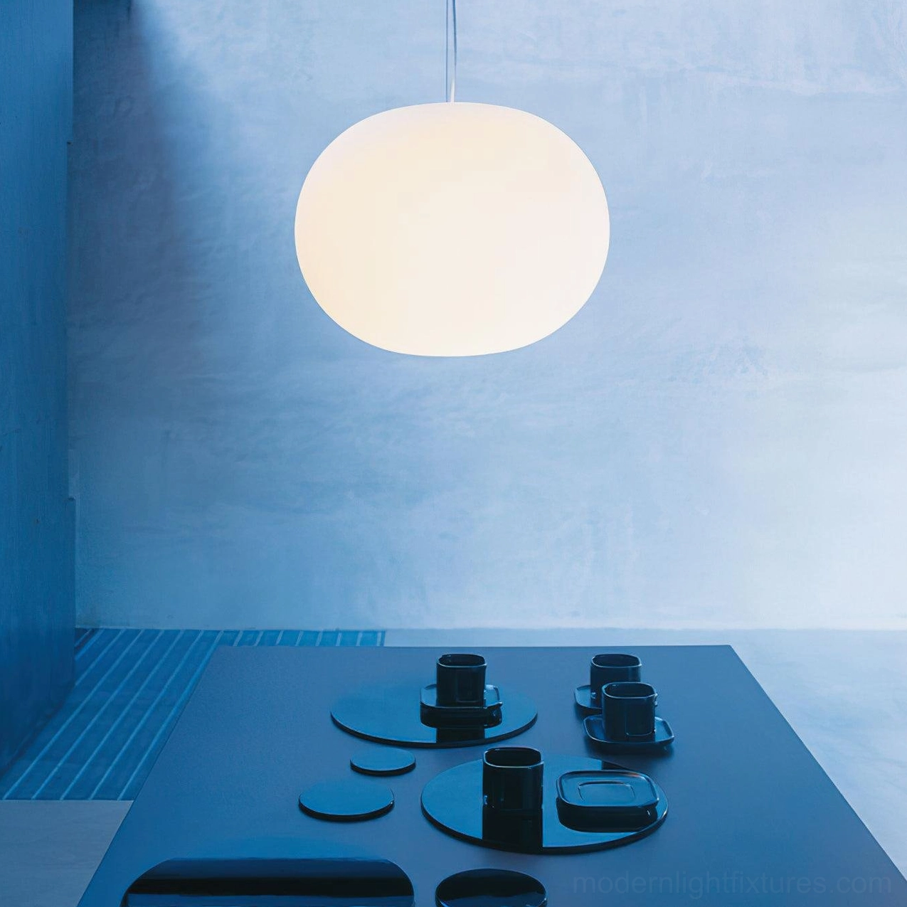 Modern frosted glass sphere pendant light in contemporary interior - minimalist hanging fixture creating soft ambient light