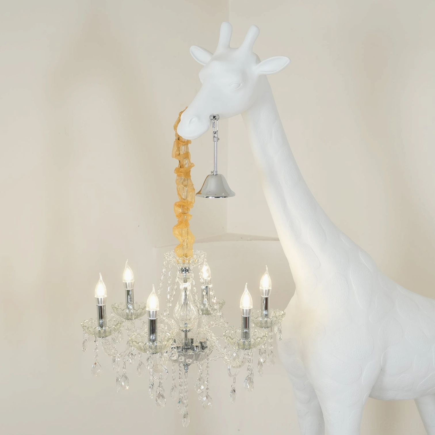 Contemporary giraffe floor lamp sculptural form creating dramatic ambient lighting with crystal chandelier