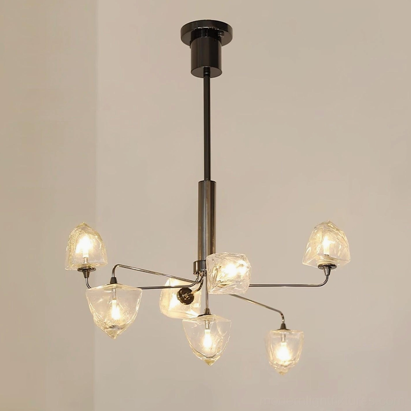 Contemporary glass chandelier with brass gold finish and clear shade details in luxury home interior