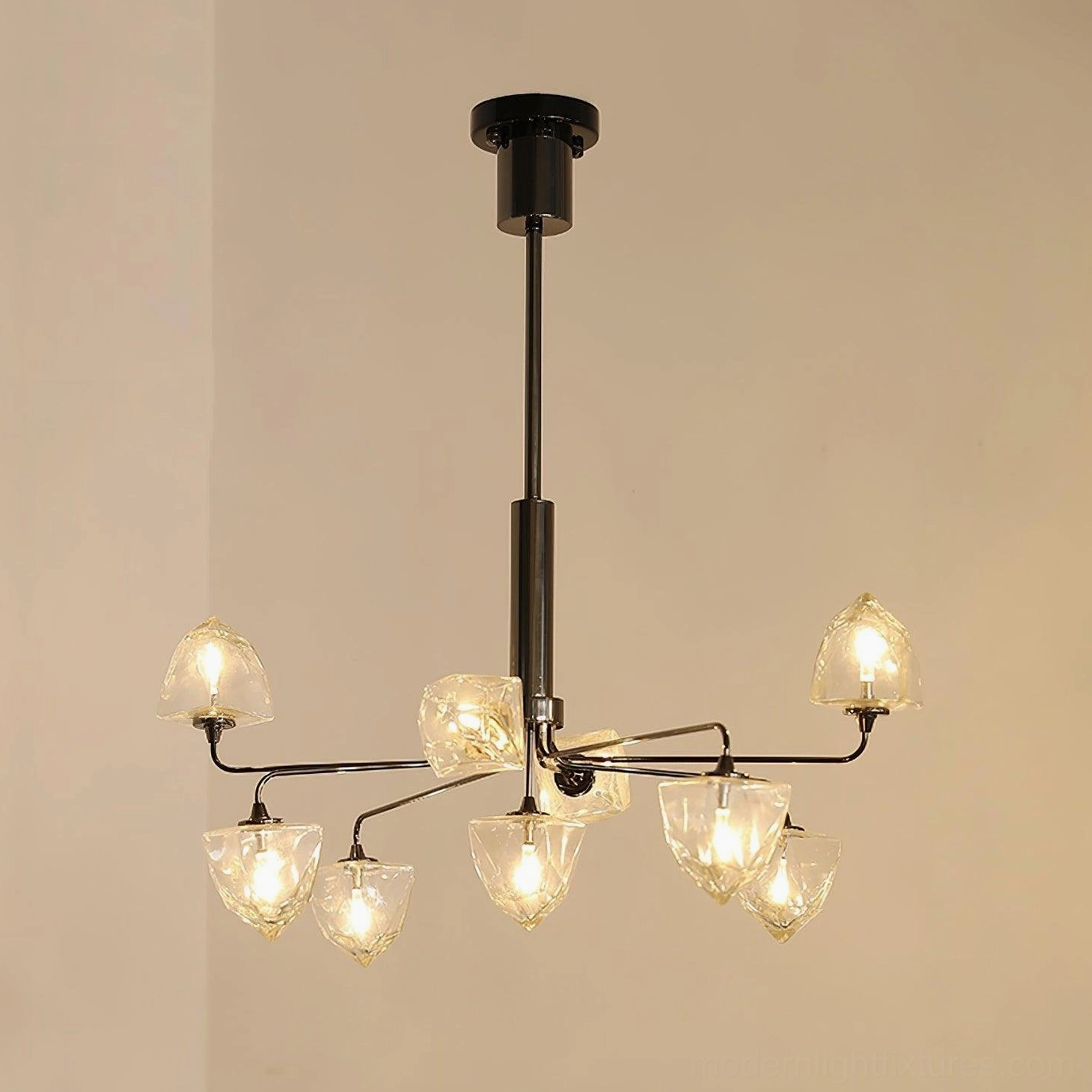 Contemporary glass chandelier with clear shades and luxury metal frame in upscale home environment