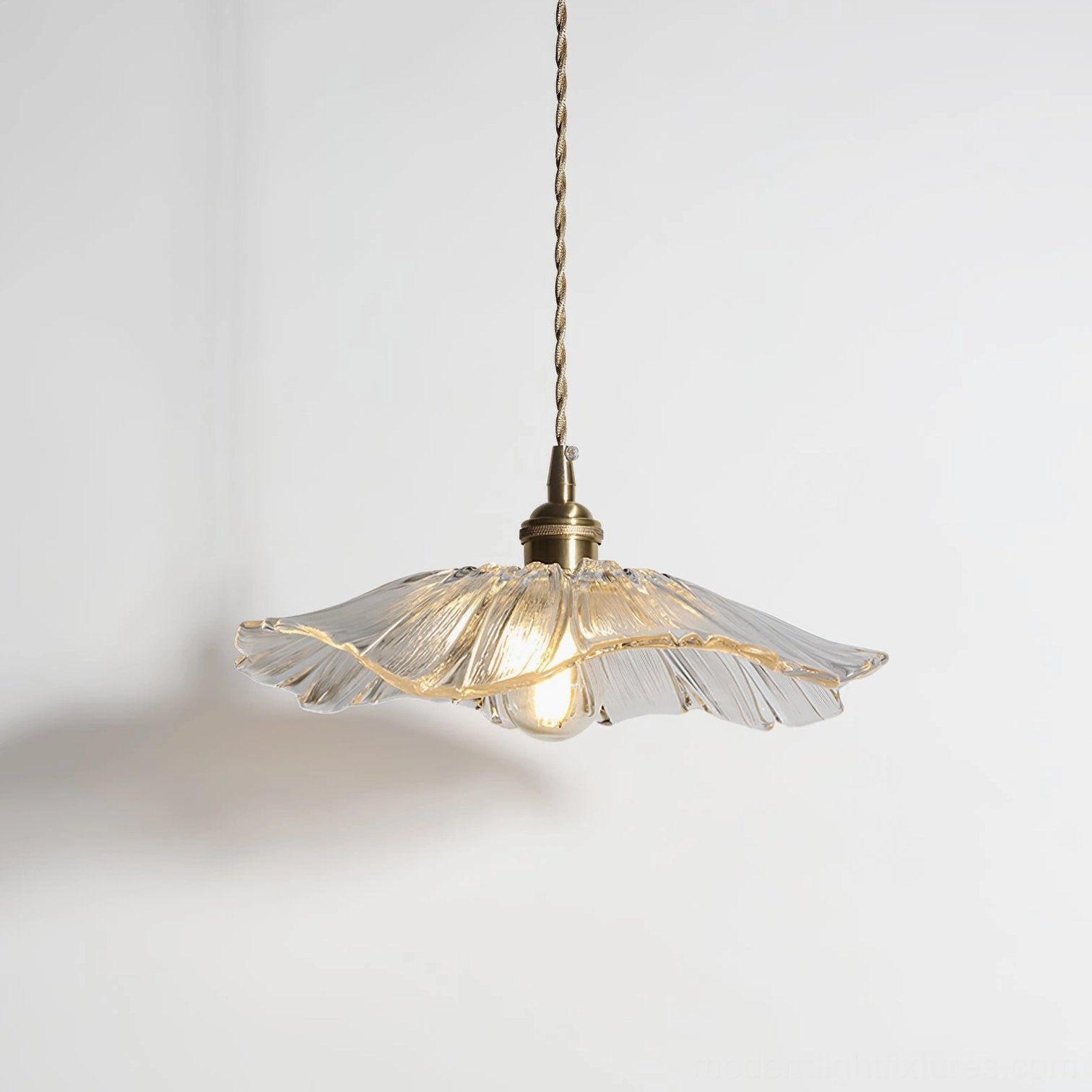 Contemporary glass flower pendant light with transparent petal shade in bedroom setting