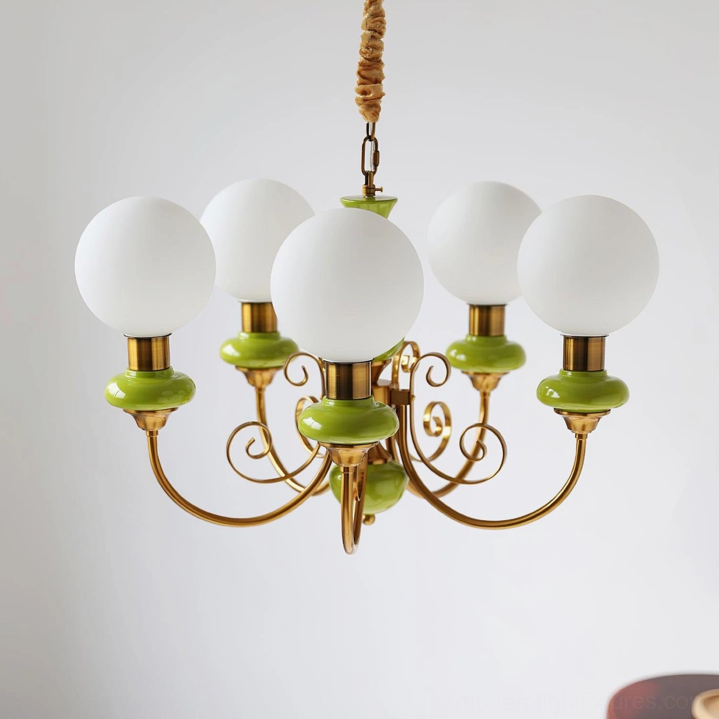 Contemporary glass pendant chandelier with swirling gold arms and milky white shades