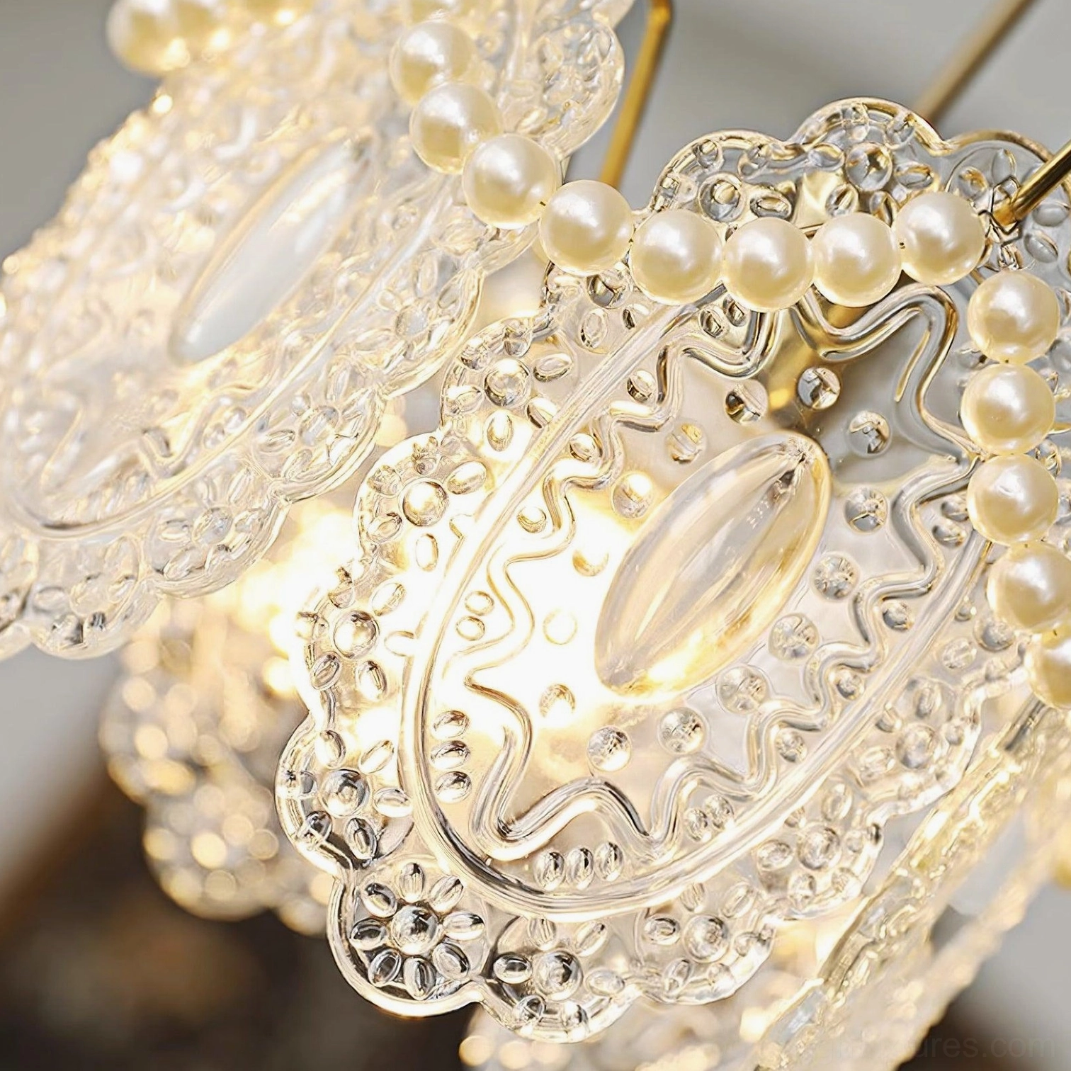 Contemporary glass petal pendant lamp with brass gold hardware and pearl trim creating luxurious home lighting