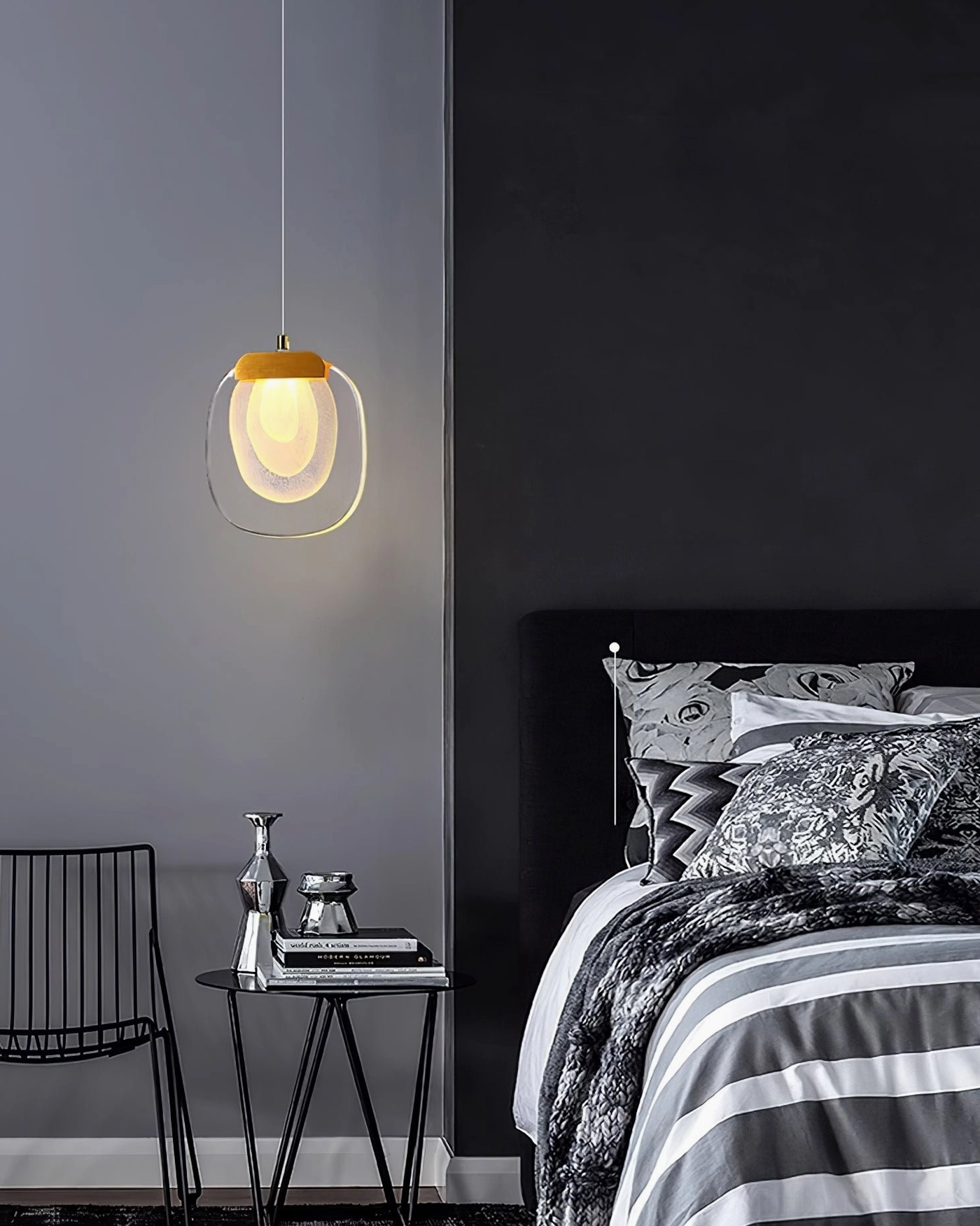 Glass ripples pendant fixture with transparent shade and warm LED glow in modern bedroom corner