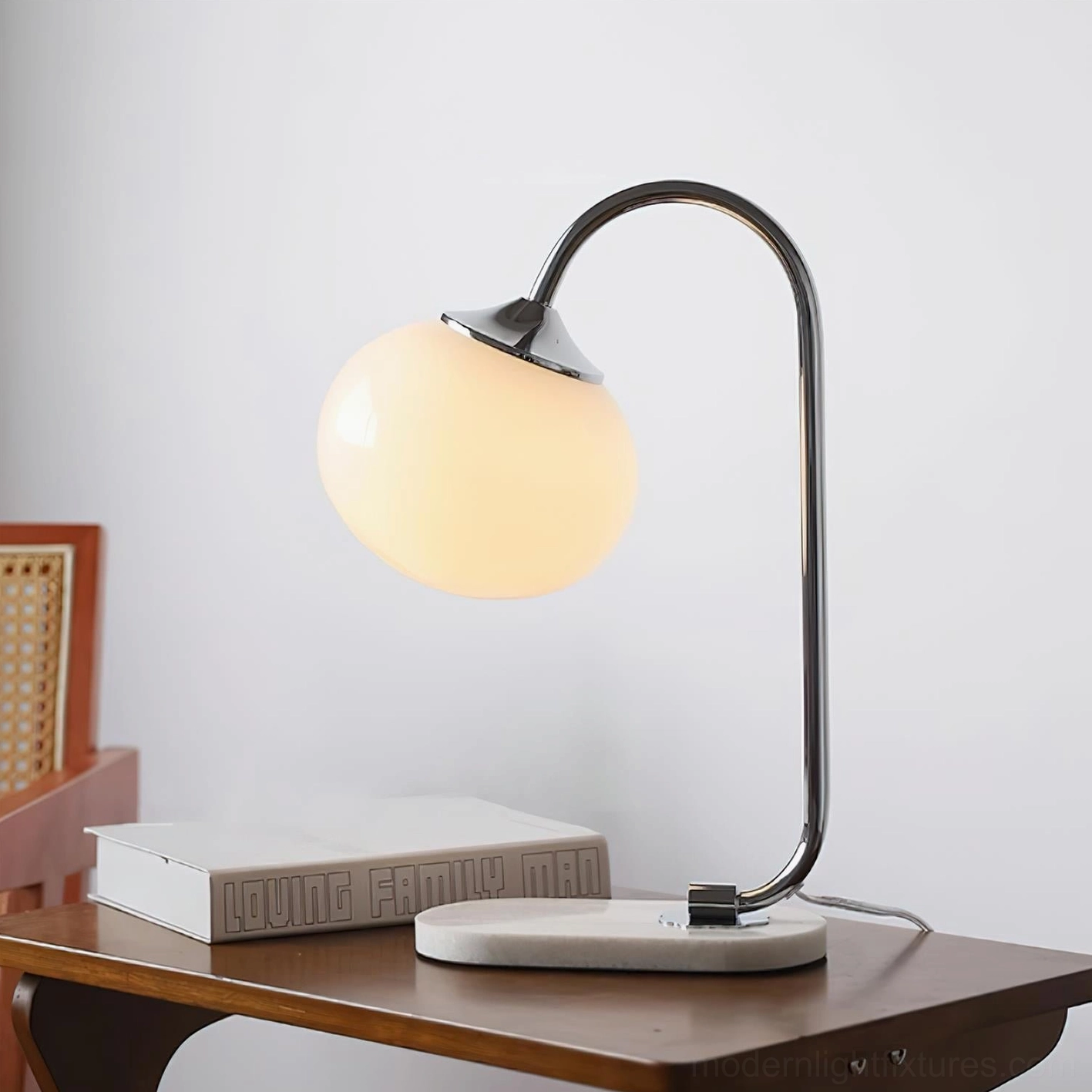 Contemporary globe table lamp with elegant curved metal arm and marble foundation lighting fixture