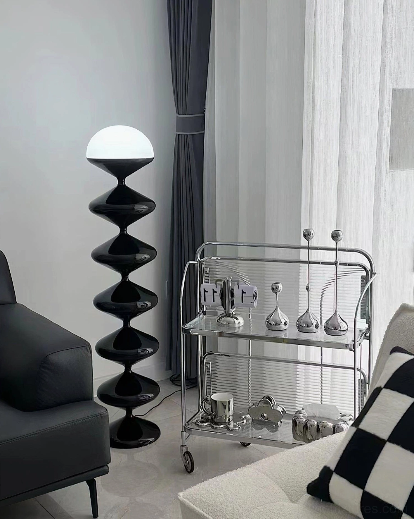 Black sculptural gourd floor lamp side view in contemporary minimalist living space with leather furniture