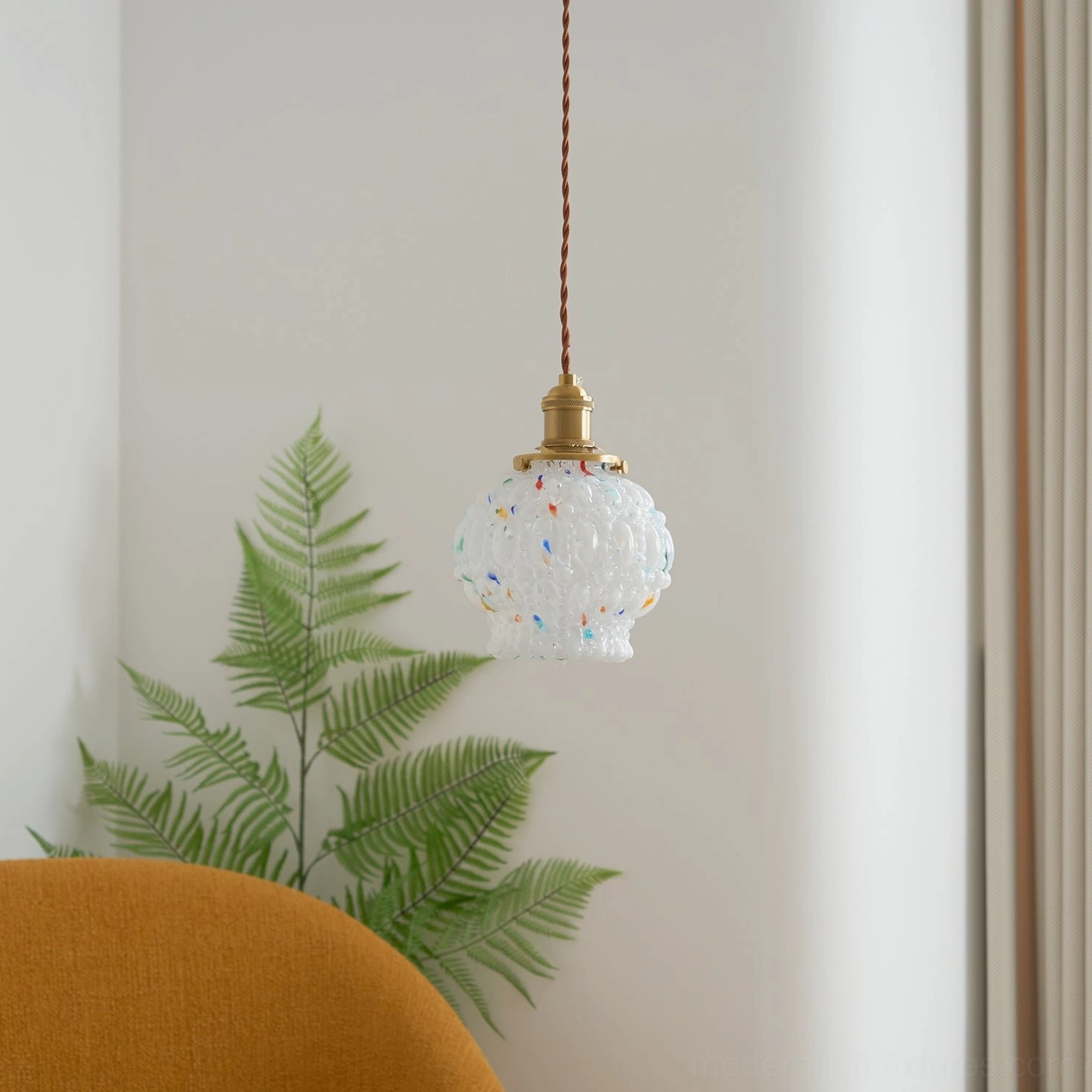 Hand-blown glass pendant lamp with frosted finish and colorful embedded speckles, brass hardware, contemporary home lighting