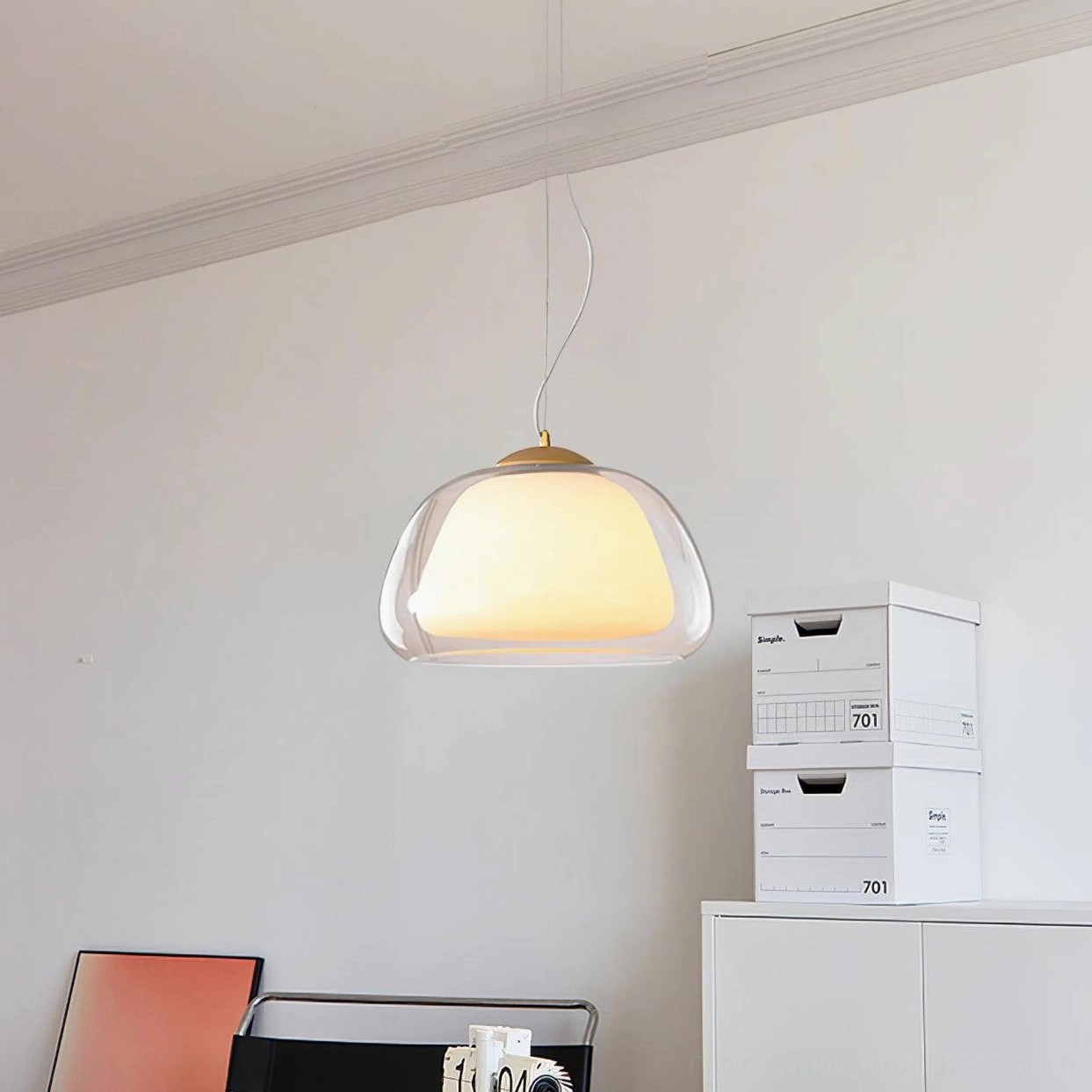 Double-layer glass pendant light mounted on white wall in minimalist home storage corner, clean design aesthetic