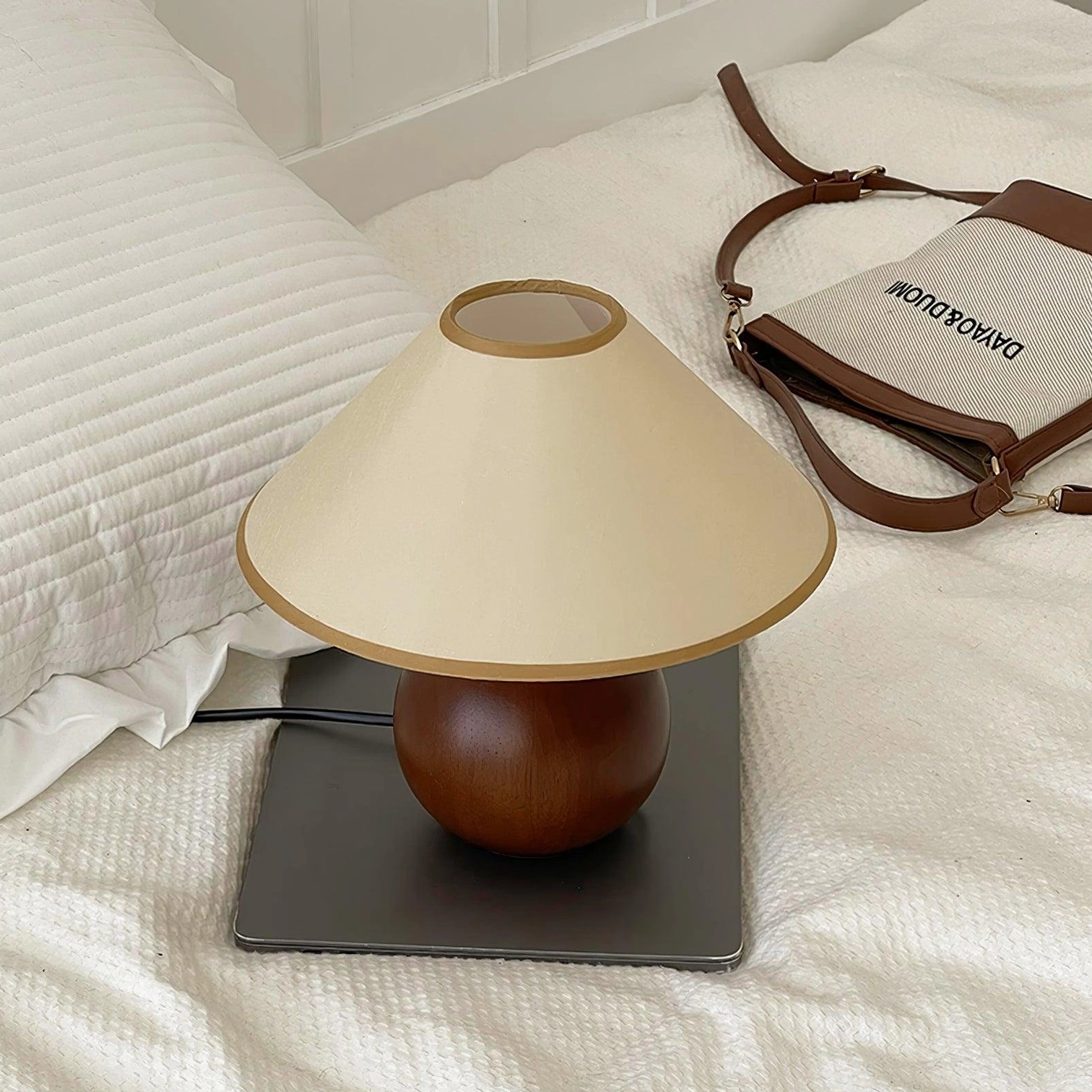 Contemporary wooden table lamp base profile showing spherical form and wood texture