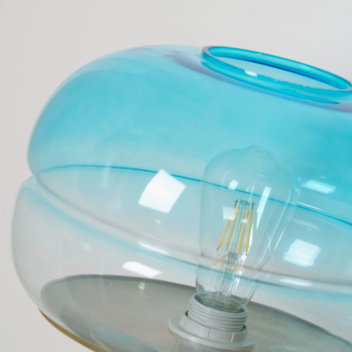 Contemporary tiered glass table lamp showing light refraction through layered glass shade design