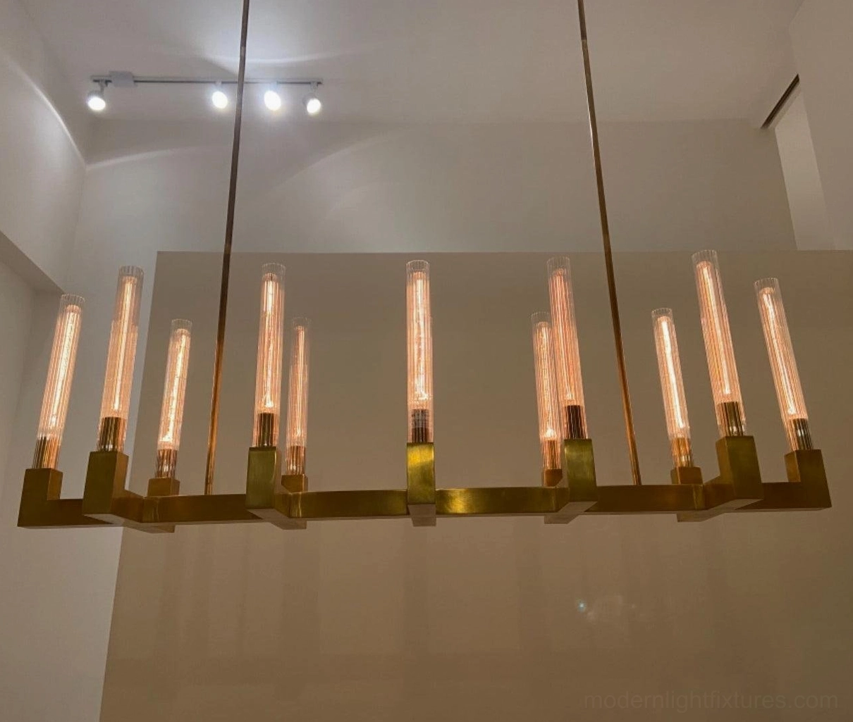 Contemporary linear chandelier brass frame clear glass shades minimalist design