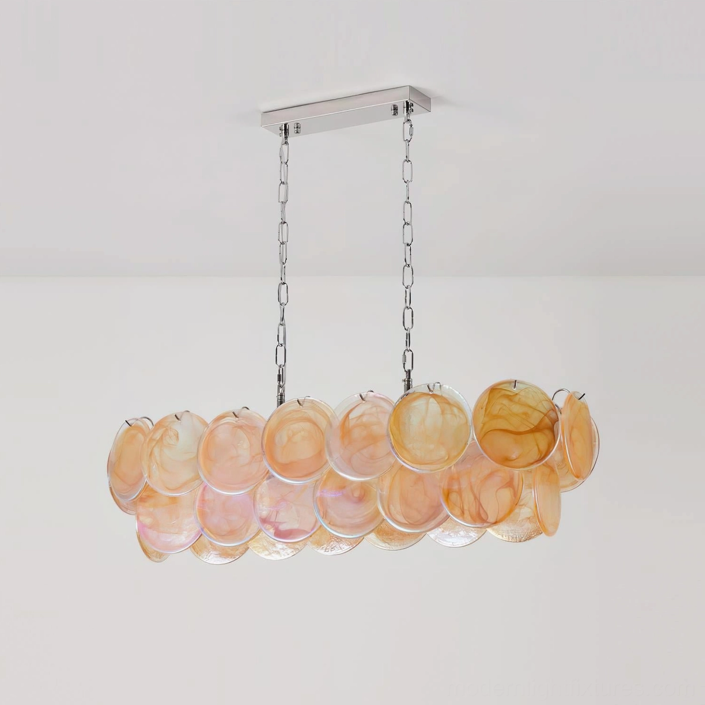 Contemporary linear glass disc chandelier with colorful orange marbled shades in studio setting