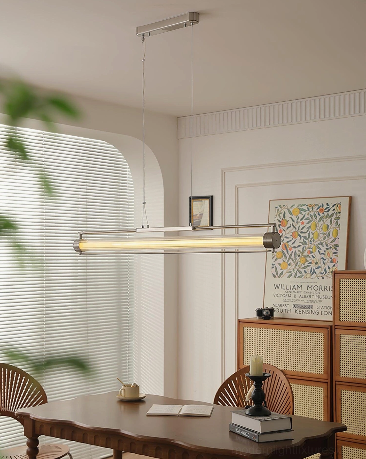 Modern linear LED pendant above wooden dining table with rattan chairs - warm white lighting in vintage-inspired room