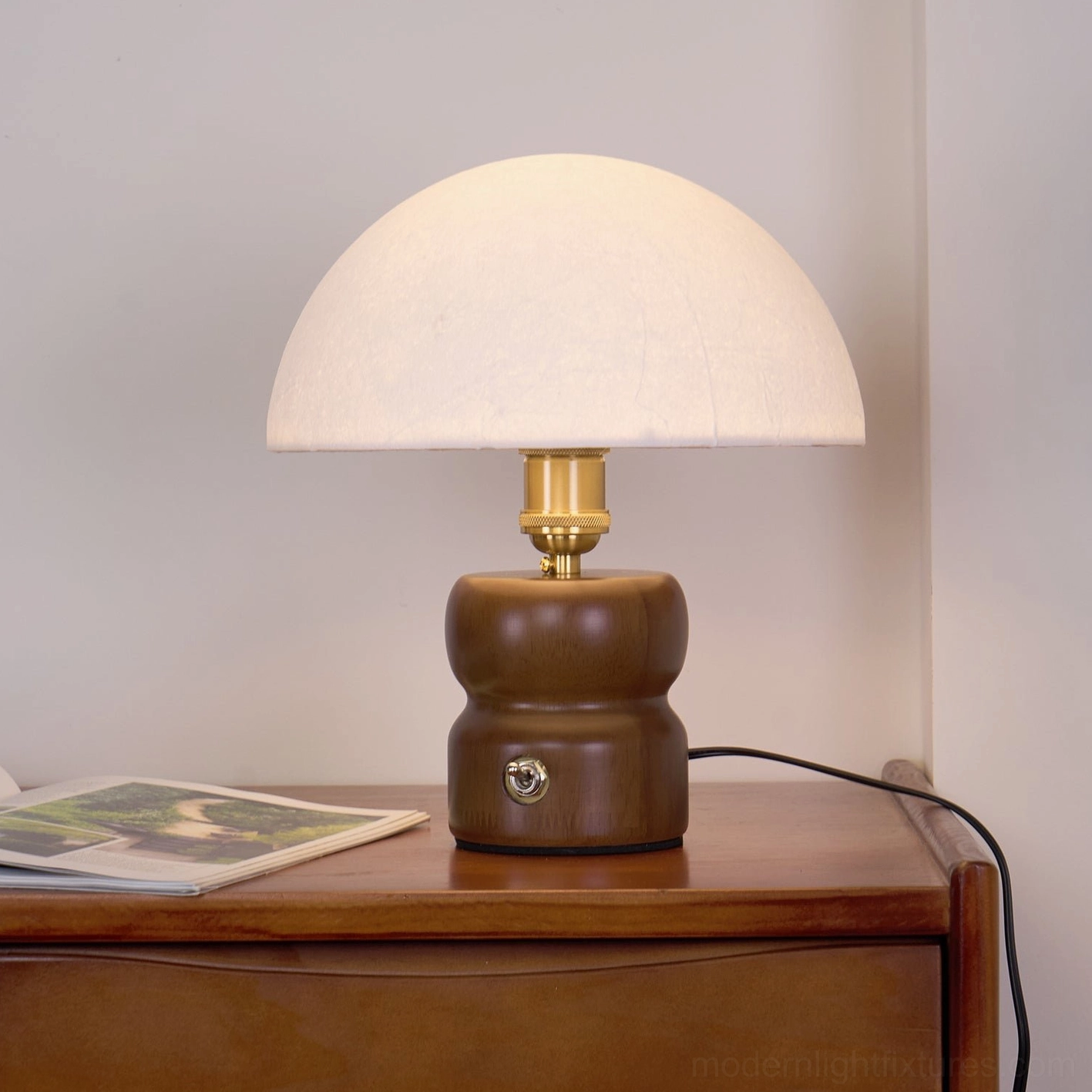 Contemporary minimalist mushroom lamp with warm glow highlighting organic form and natural materials