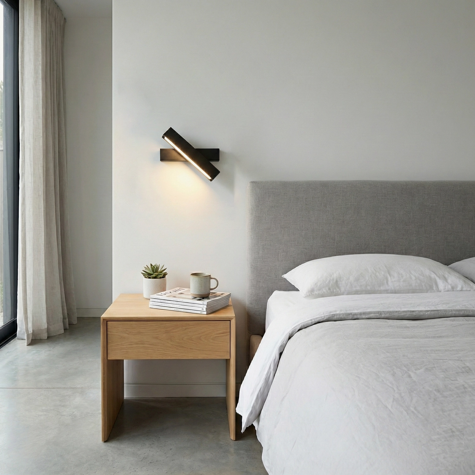 Contemporary angular matte black wall lamp in minimalist bedroom, soft warm lighting on nightstand area