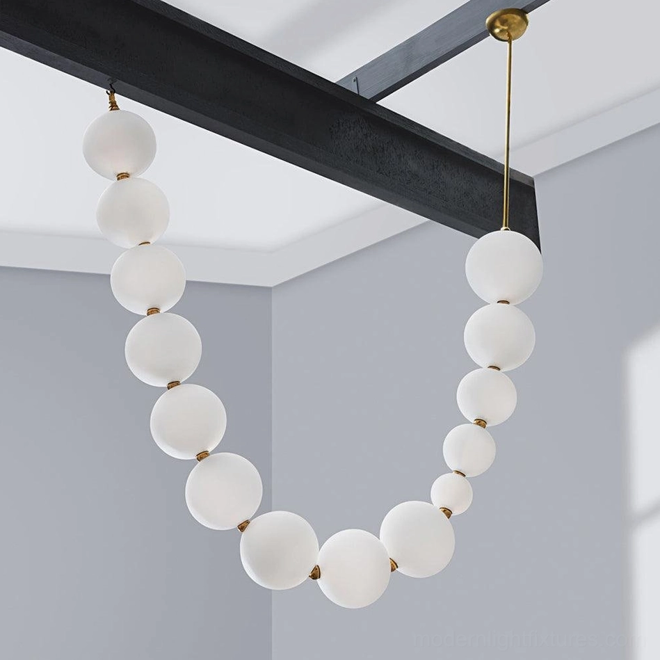 Contemporary pearl pendant light with brass hardware and integrated LED warm white illumination