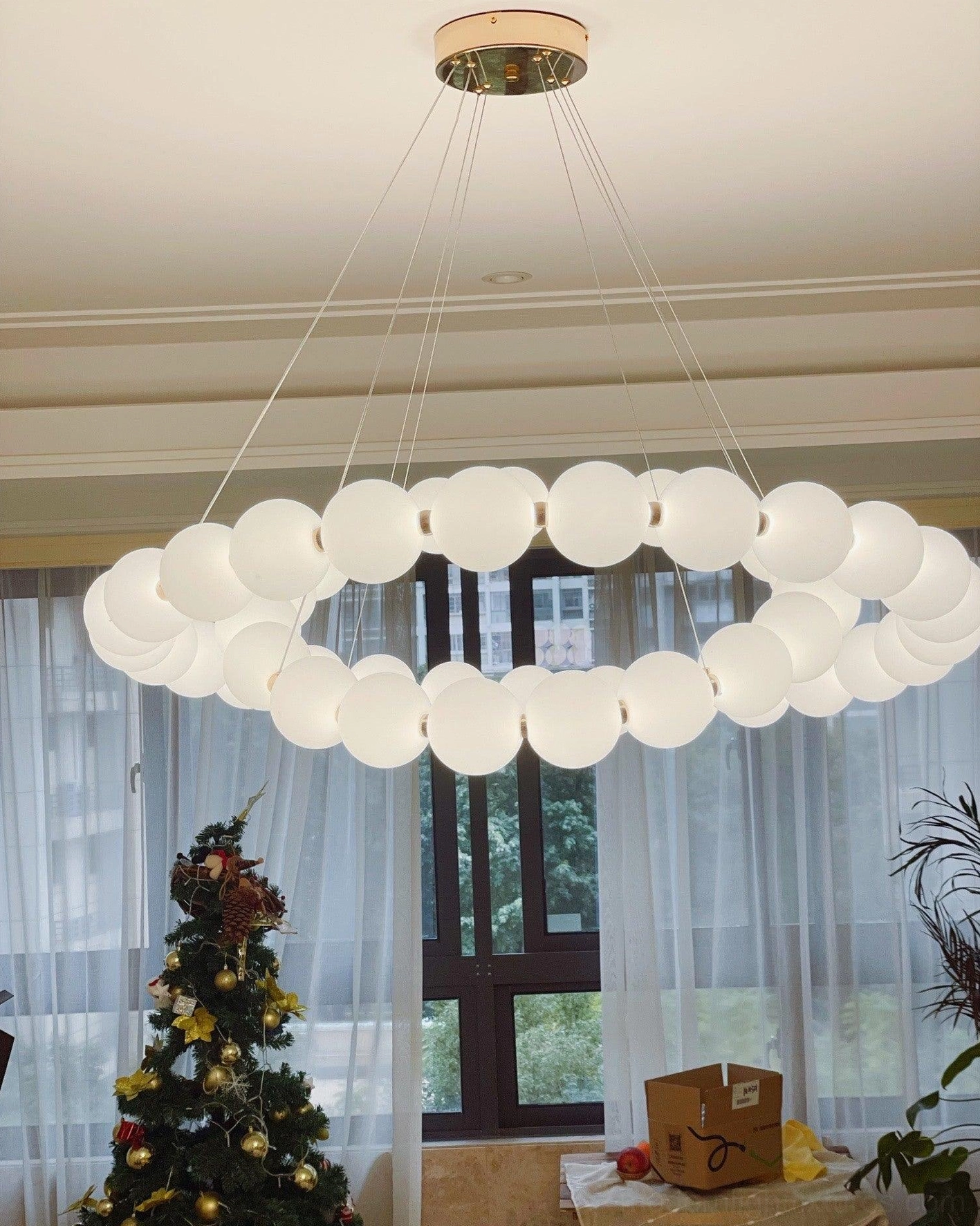 Contemporary pearl pendant light installed in upscale residential kitchen or dining area